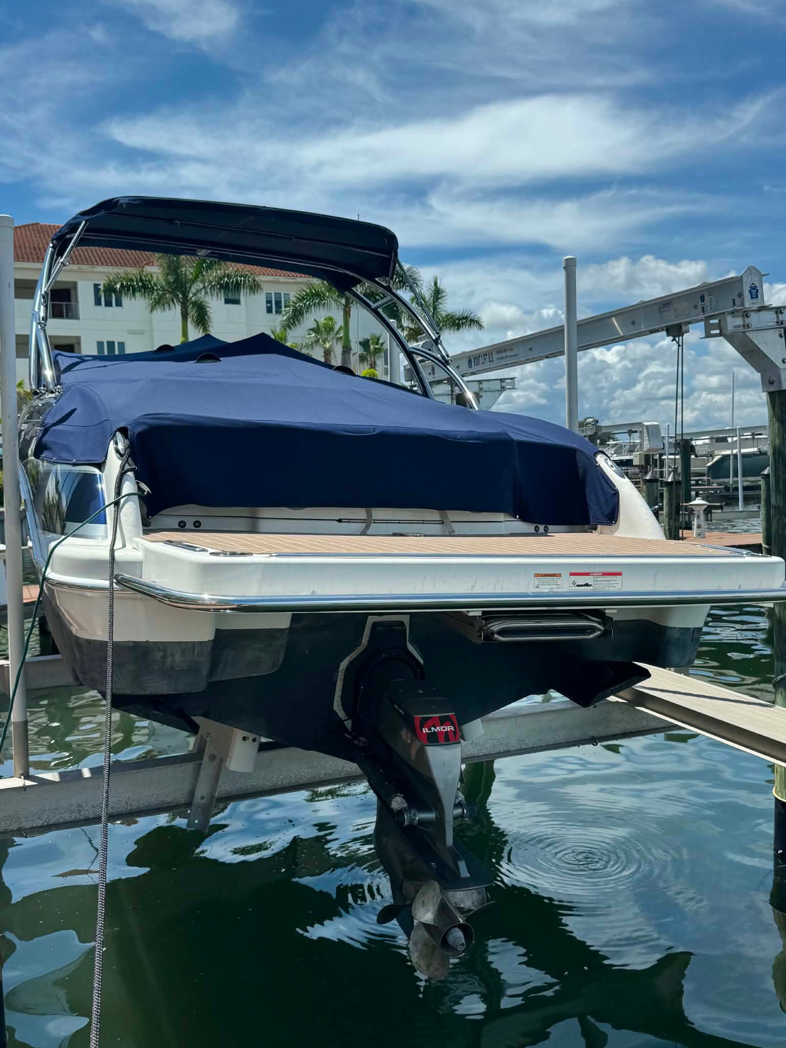 2018 Formula 270 Bowrider on boat lift, blue cover, sunny day.