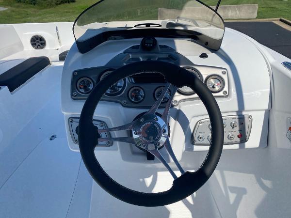 2024 Tahoe 2150 boat dashboard with steering wheel and gauges.