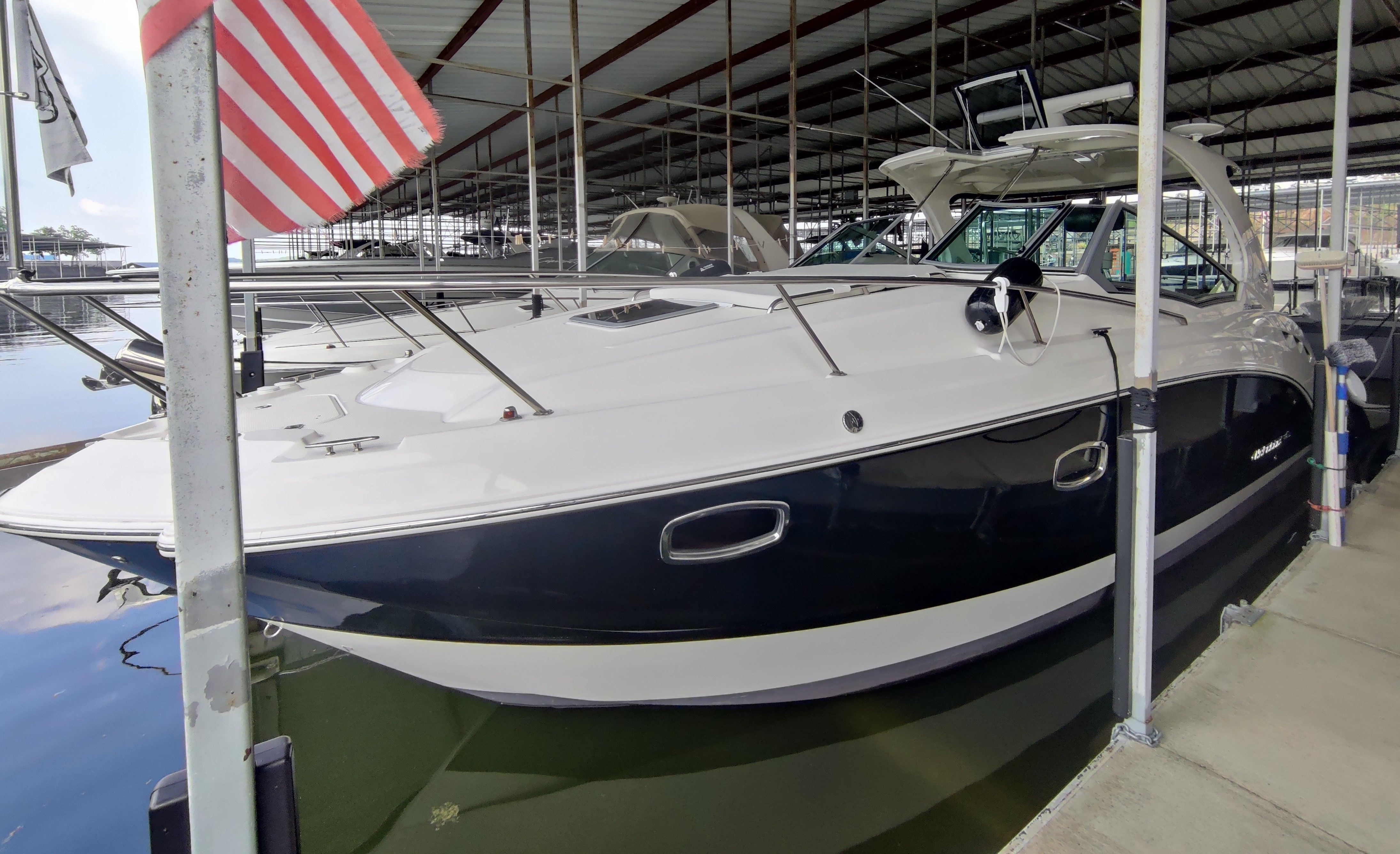 2014 Chaparral 330 Signature yacht docked in marina.