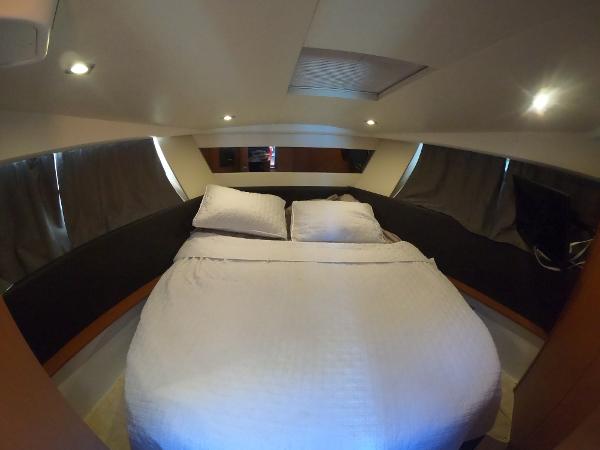 Luxurious bedroom cabin in a 2017 Jeanneau NC 11 yacht with cozy bedding.
