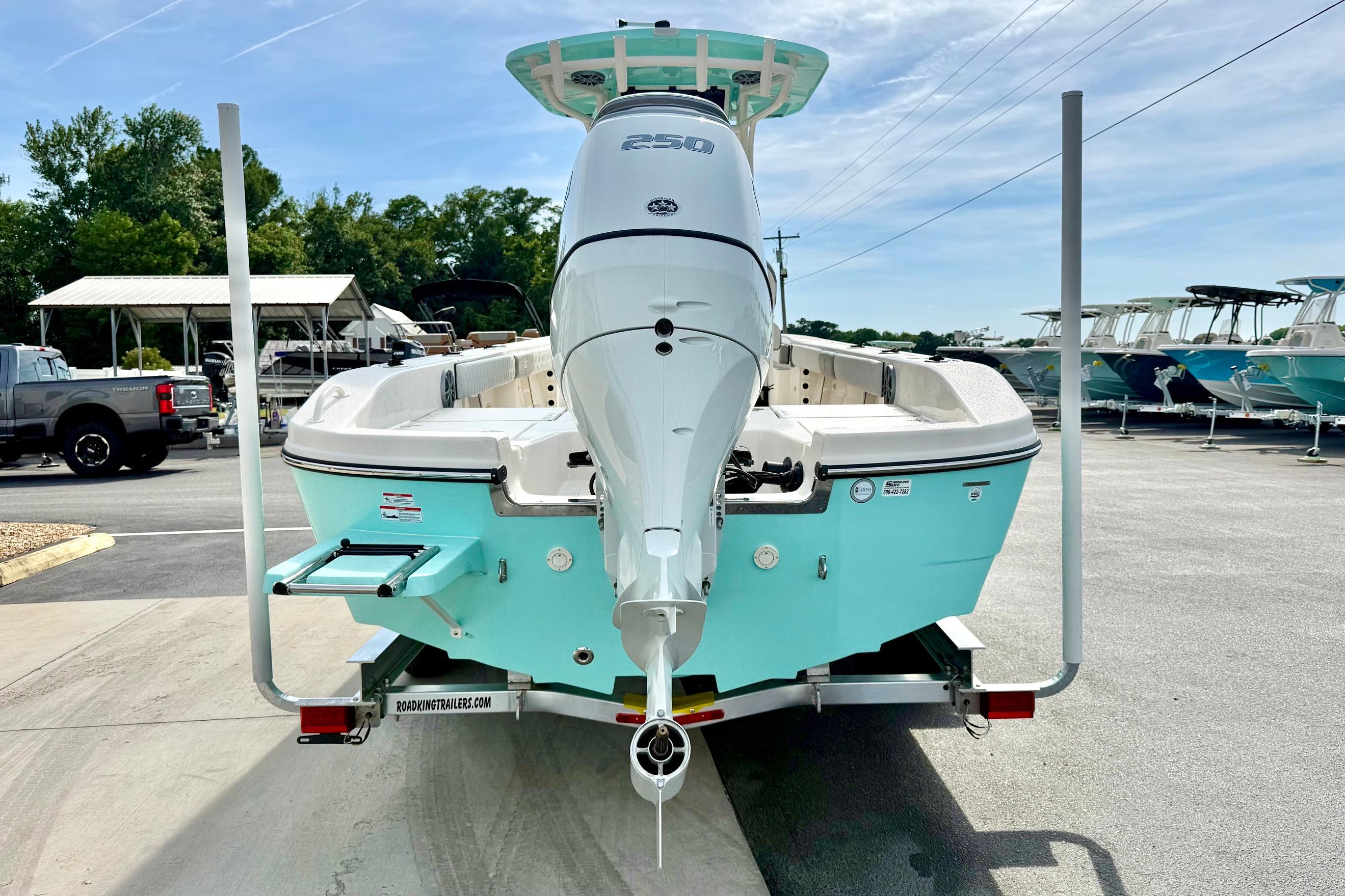 2026 Carolina Skiff 24 Ultra Elite boat on trailer, featuring powerful outboard motor.