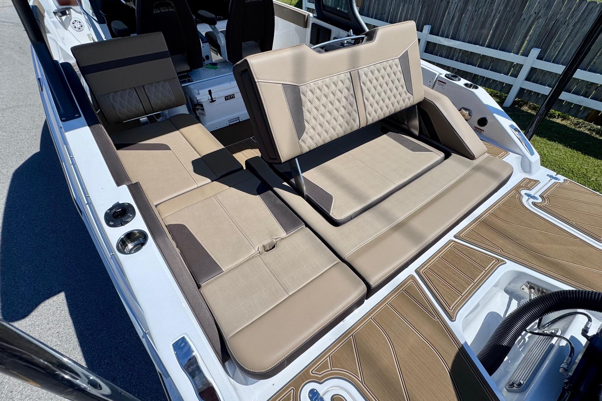 2026 Monterey Elite 27 OB boat interior with beige seating and modern design.