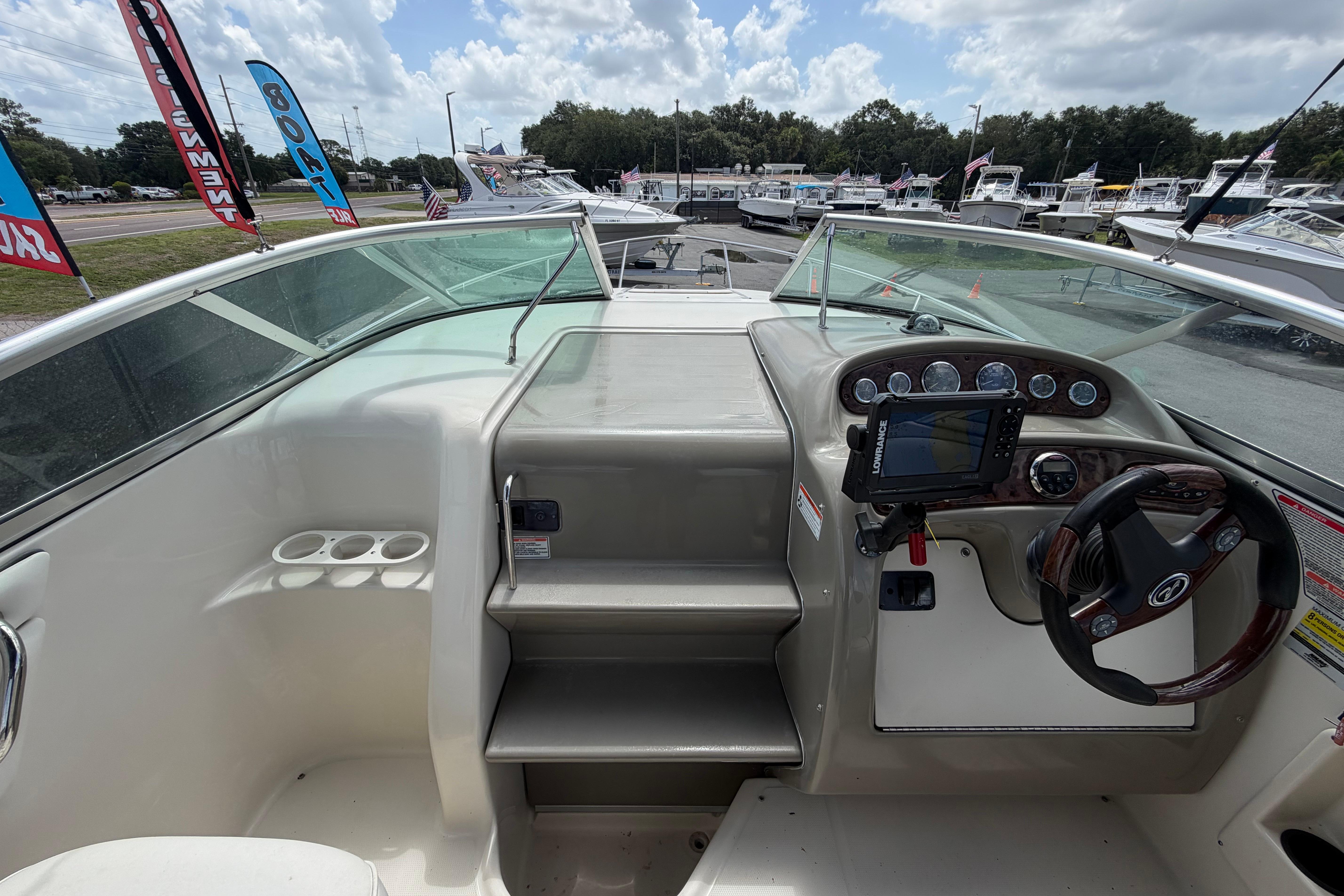 2006 Sea Ray 250 Amberjack helm with steering wheel and navigation system.