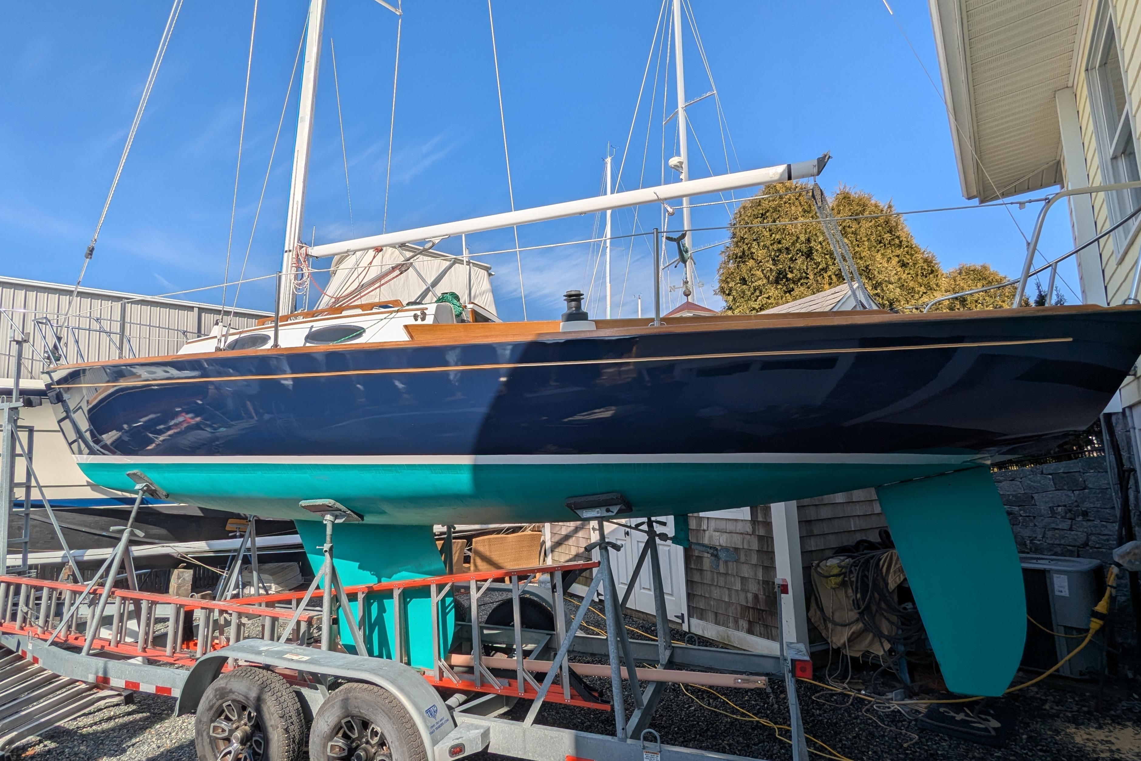 Alerion Express 28 sailboat, 2012 model, on a trailer in a boatyard.