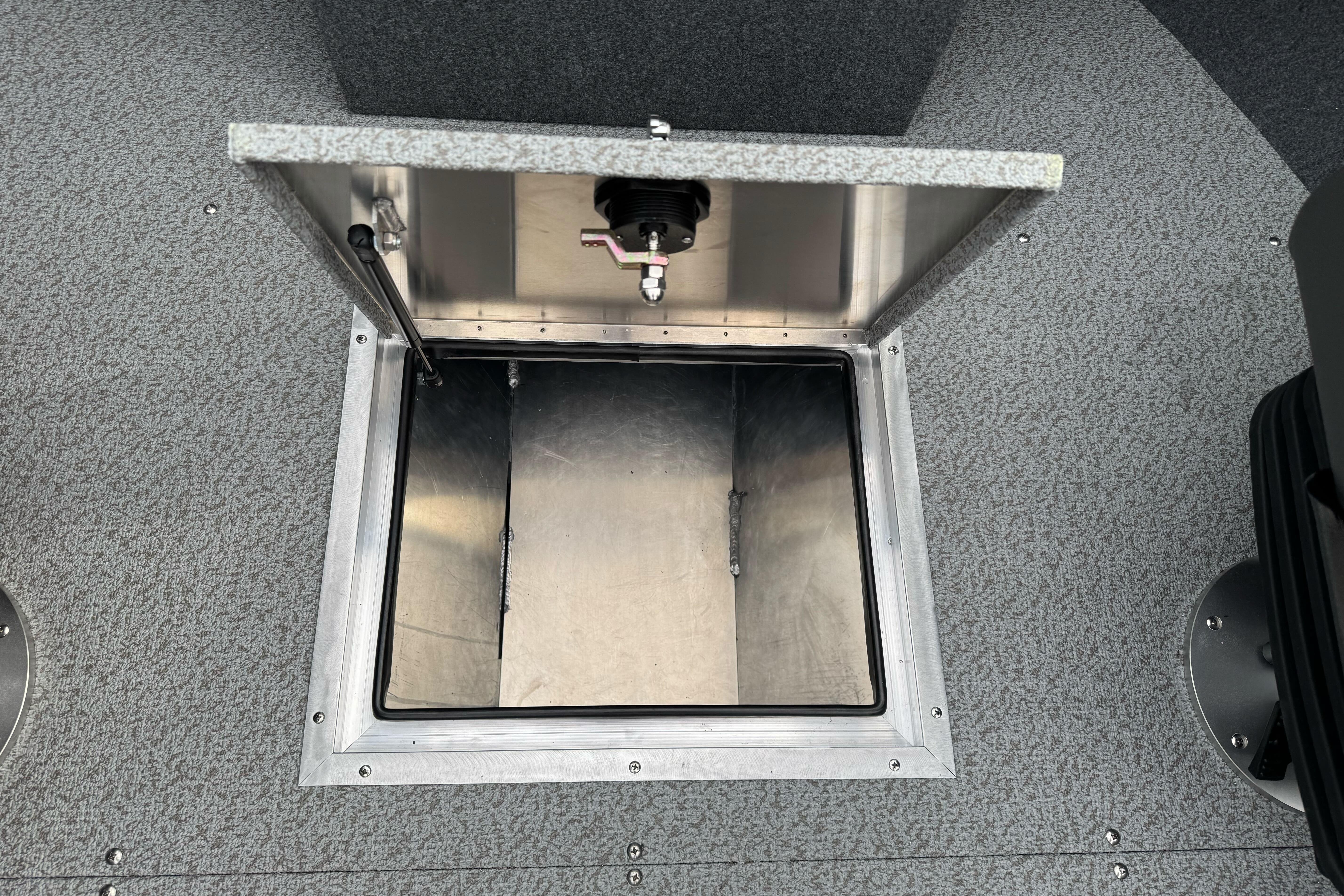 Open storage compartment in 2026 Lund 185 Heavy Gauge boat interior.