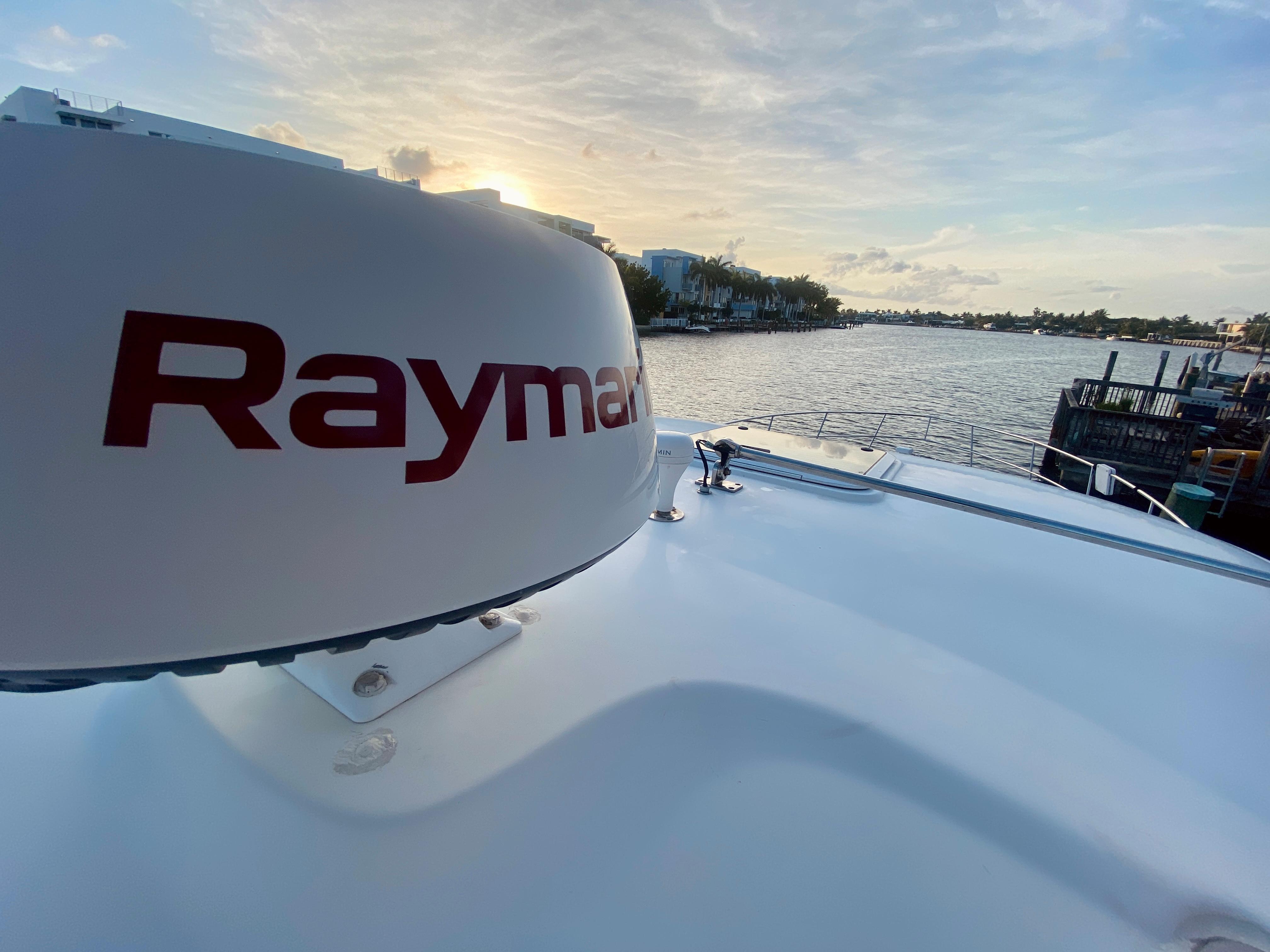 Raymarine radar on a 2005 Sea Ray 420 Sundancer at sunset by the water.