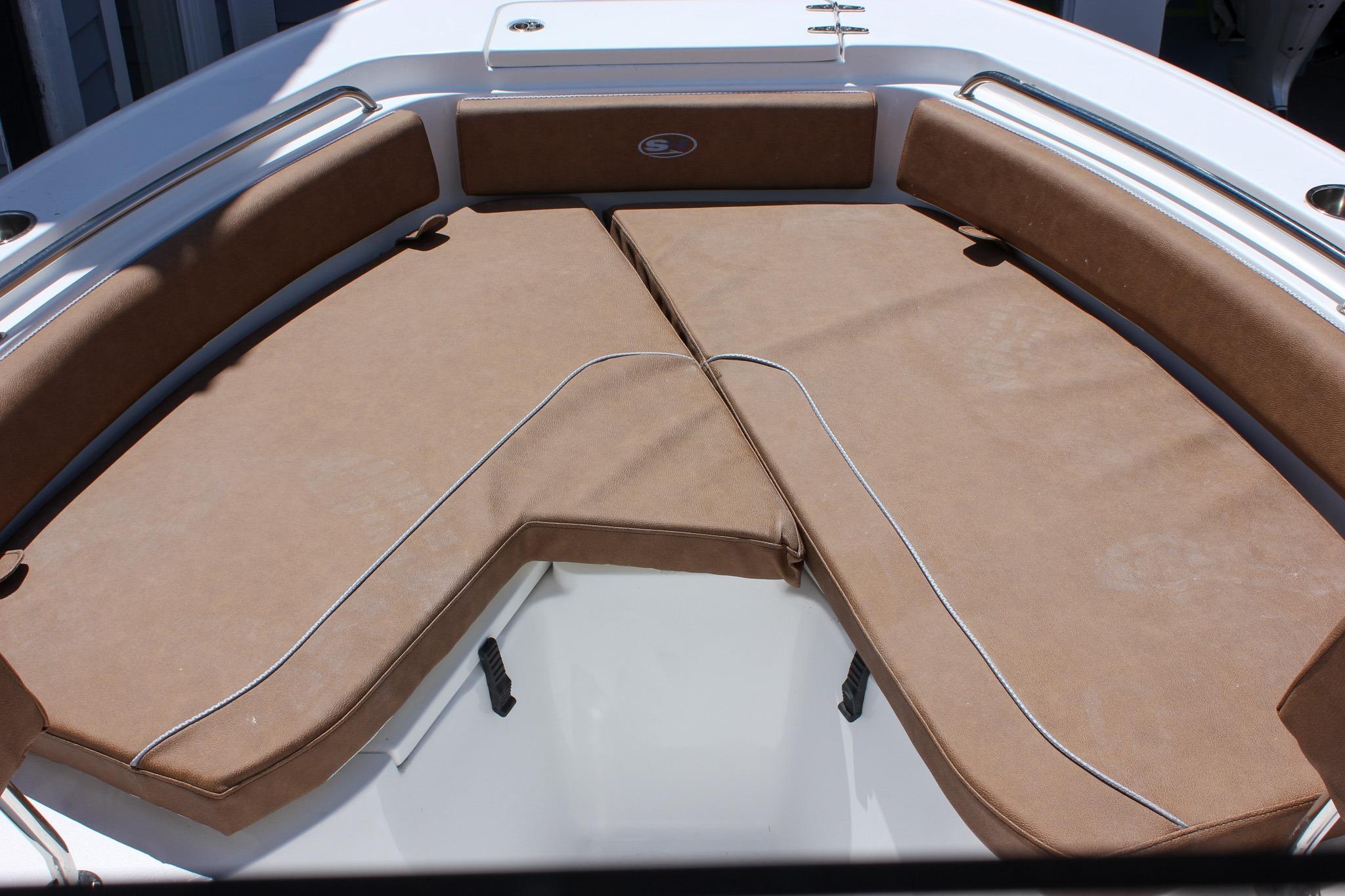 2027 Sea Hunt Ultra 234 boat interior with brown cushioned seating.