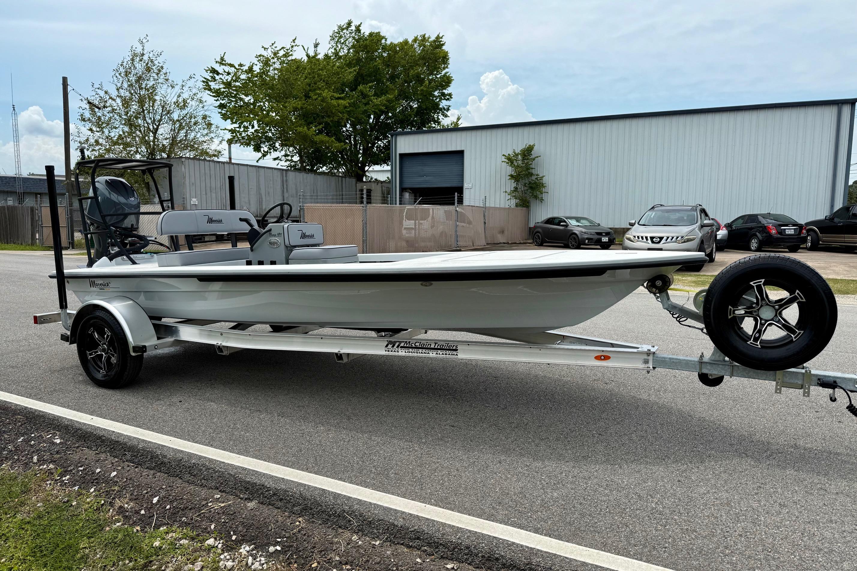 2026 Maverick 17 HPX-S boat on trailer, parked near industrial building.