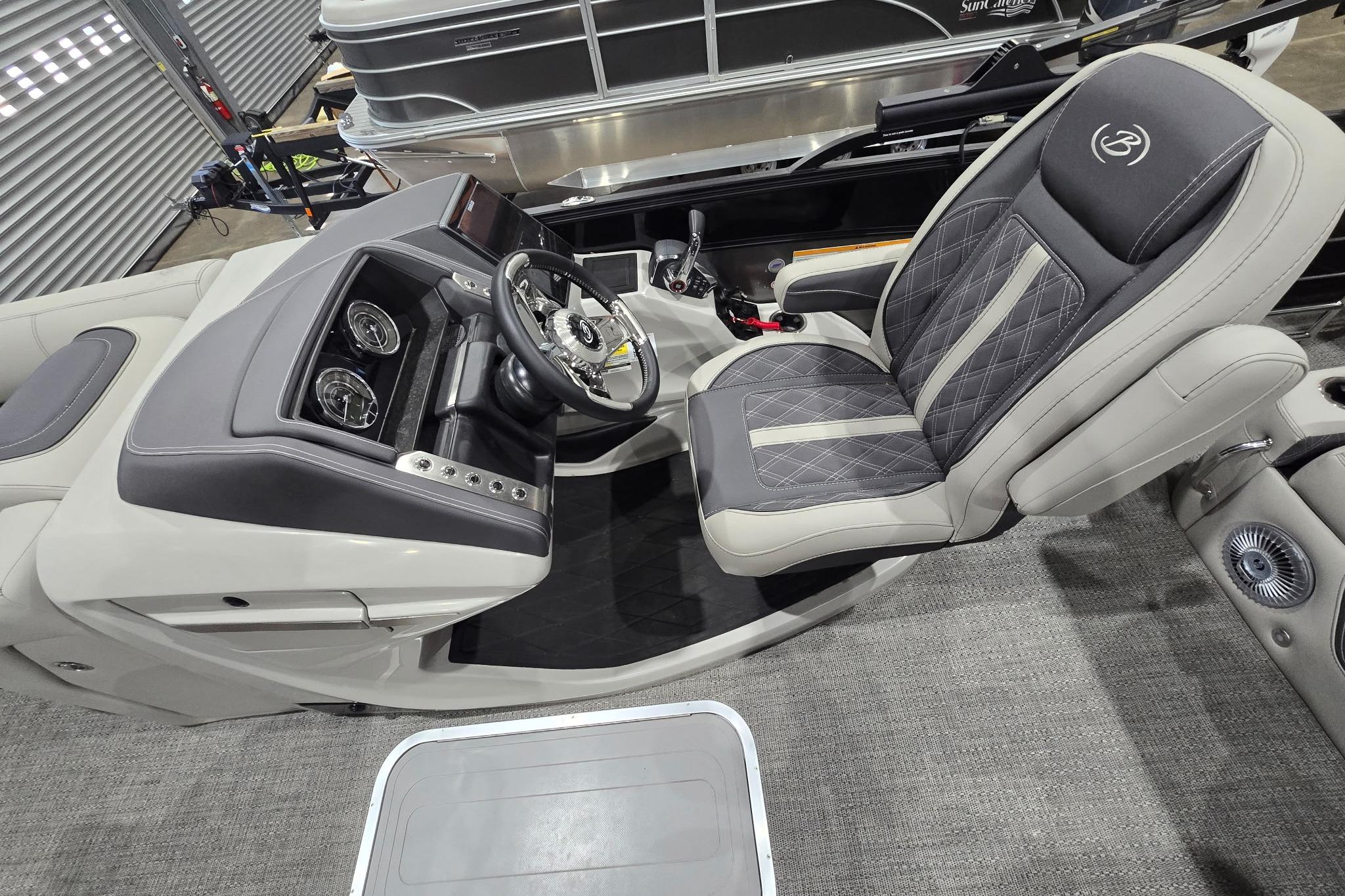 2025 Barletta Lusso 23UC boat interior with luxurious captain's chair and modern dashboard.
