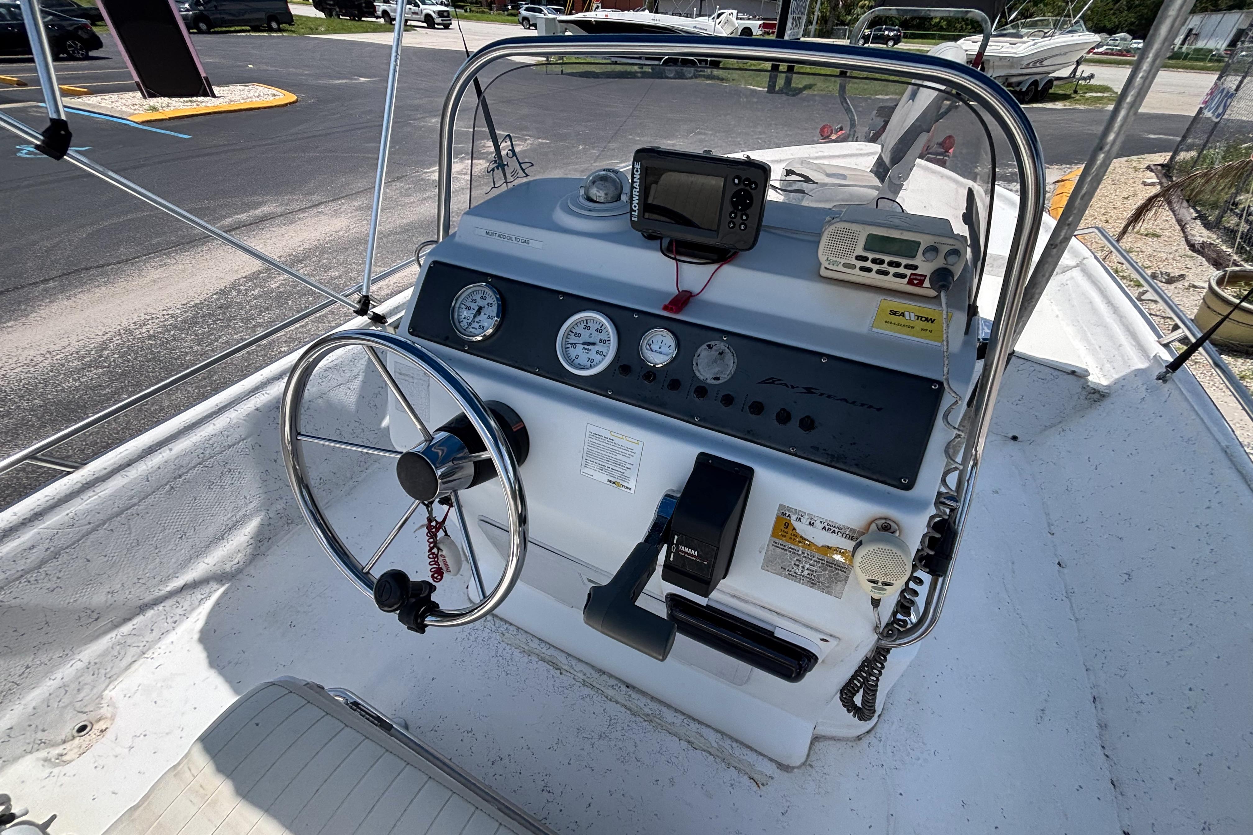 2000 VIP 1880 BAY STEALTH boat dashboard with steering wheel and navigation instruments.