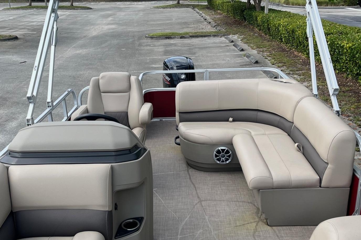 2025 Sun Tracker Party Barge 18 DLX with beige seating and spacious layout.