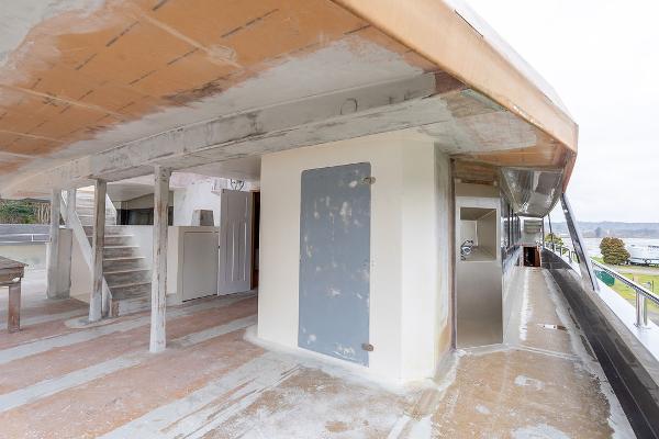 Unfinished interior of 2025 Catamaran Bloomfield 86 Motorsailor, showcasing construction details.