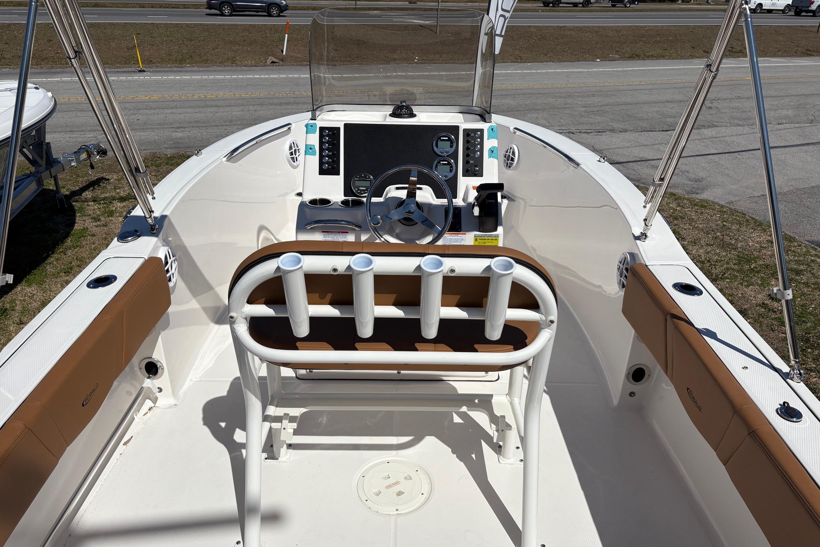 2026 Robalo R180 Center Console boat interior with steering wheel and rod holders.