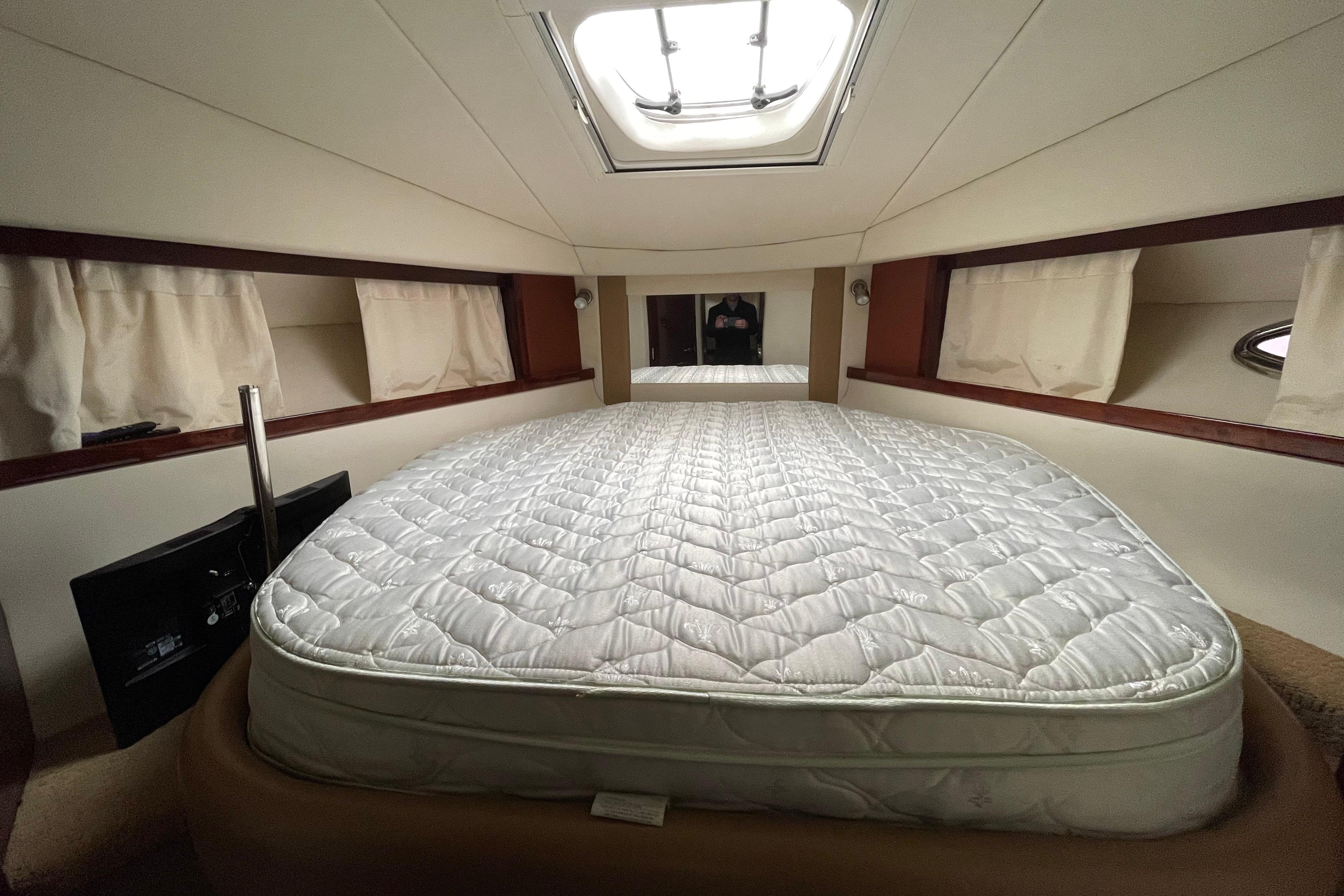 Cozy cabin interior of 2010 Sea Ray 390 Sundancer with a comfortable bed.