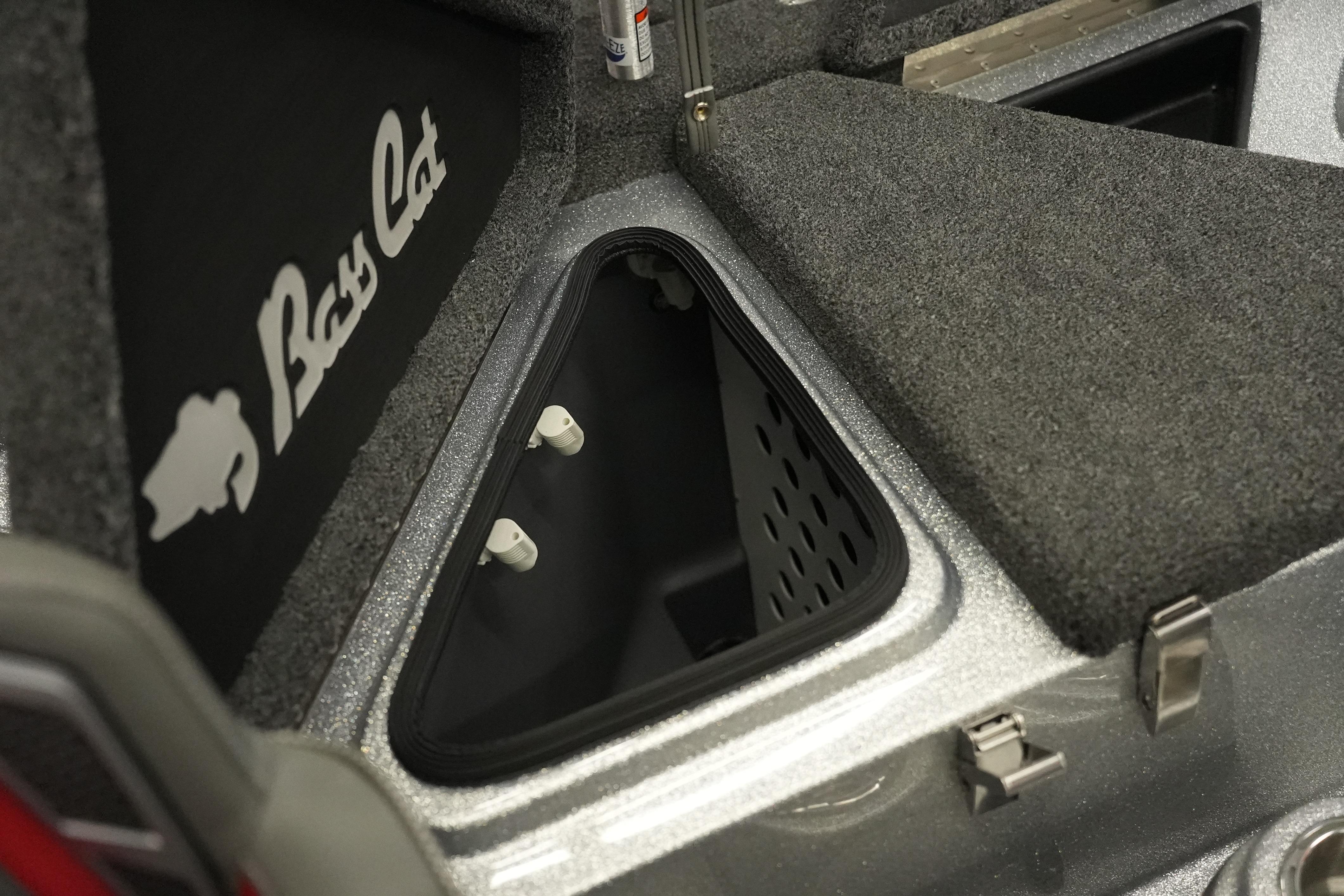 2026 Bass Cat Lynx STS boat storage compartment with carpeted interior and logo.