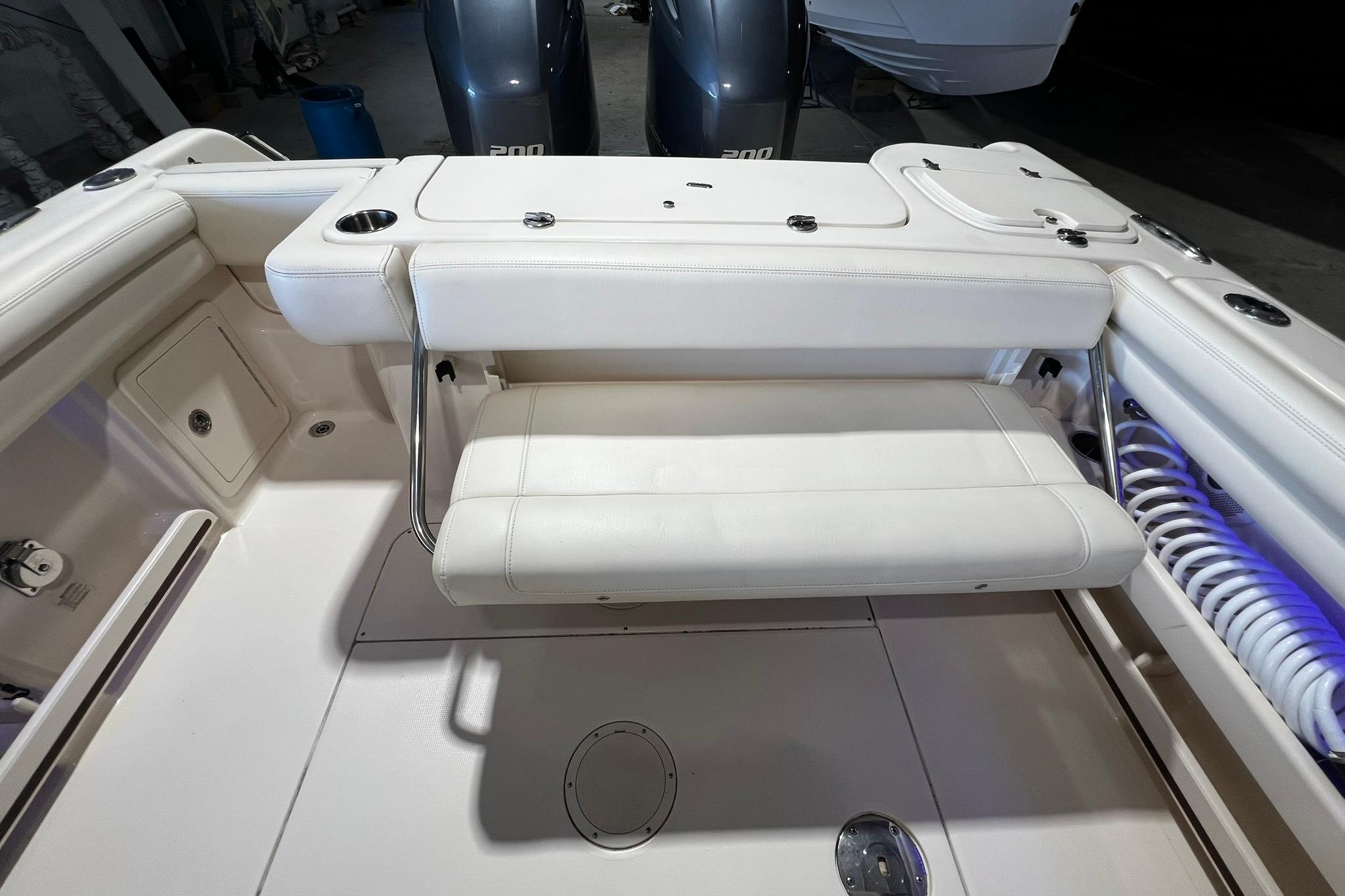 2014 Grady-White Freedom 275 boat interior with foldable seating and twin engines.