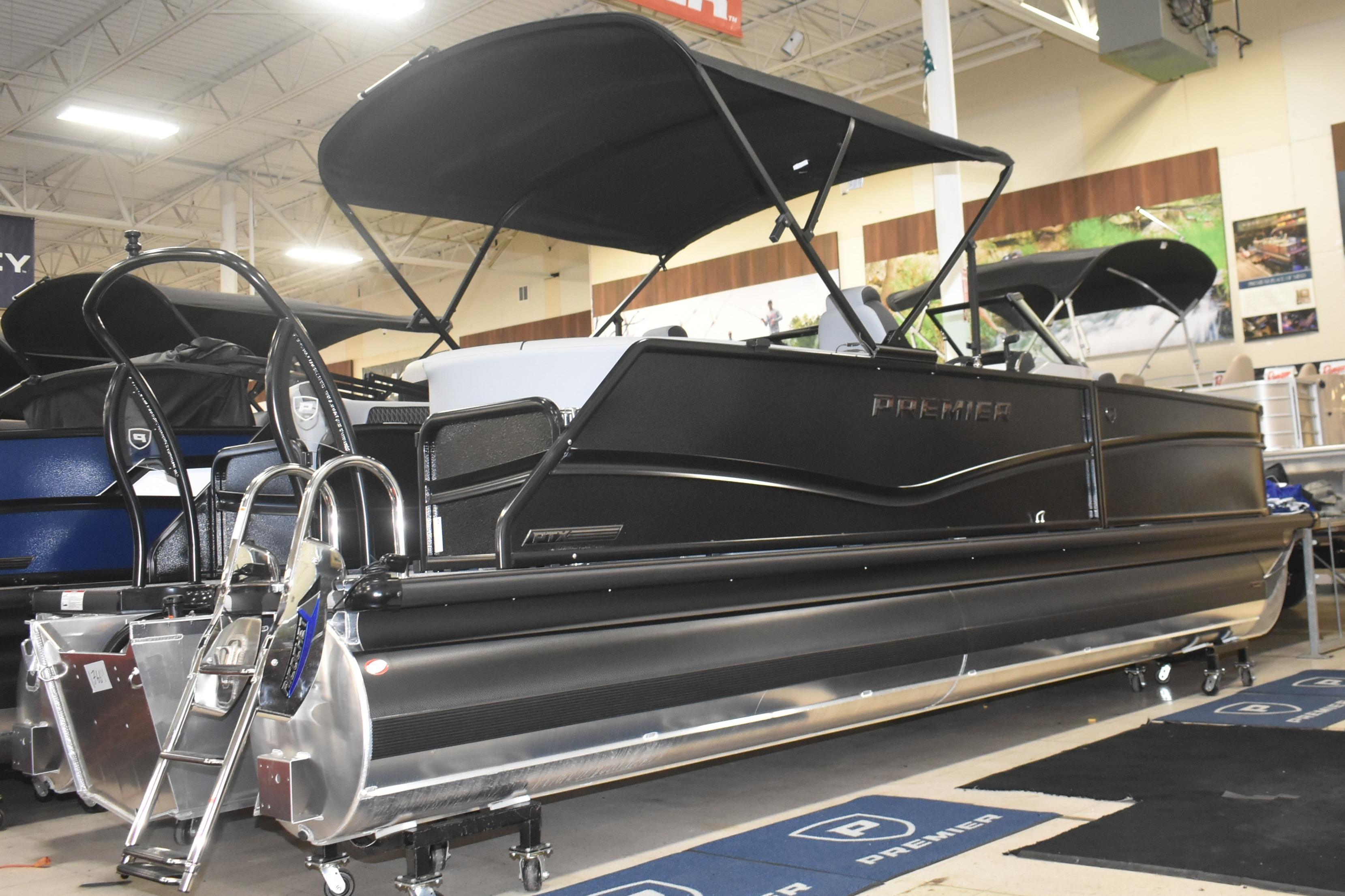 2026 Premier 250 Solaris Sport pontoon boat displayed indoors with sleek black design.
