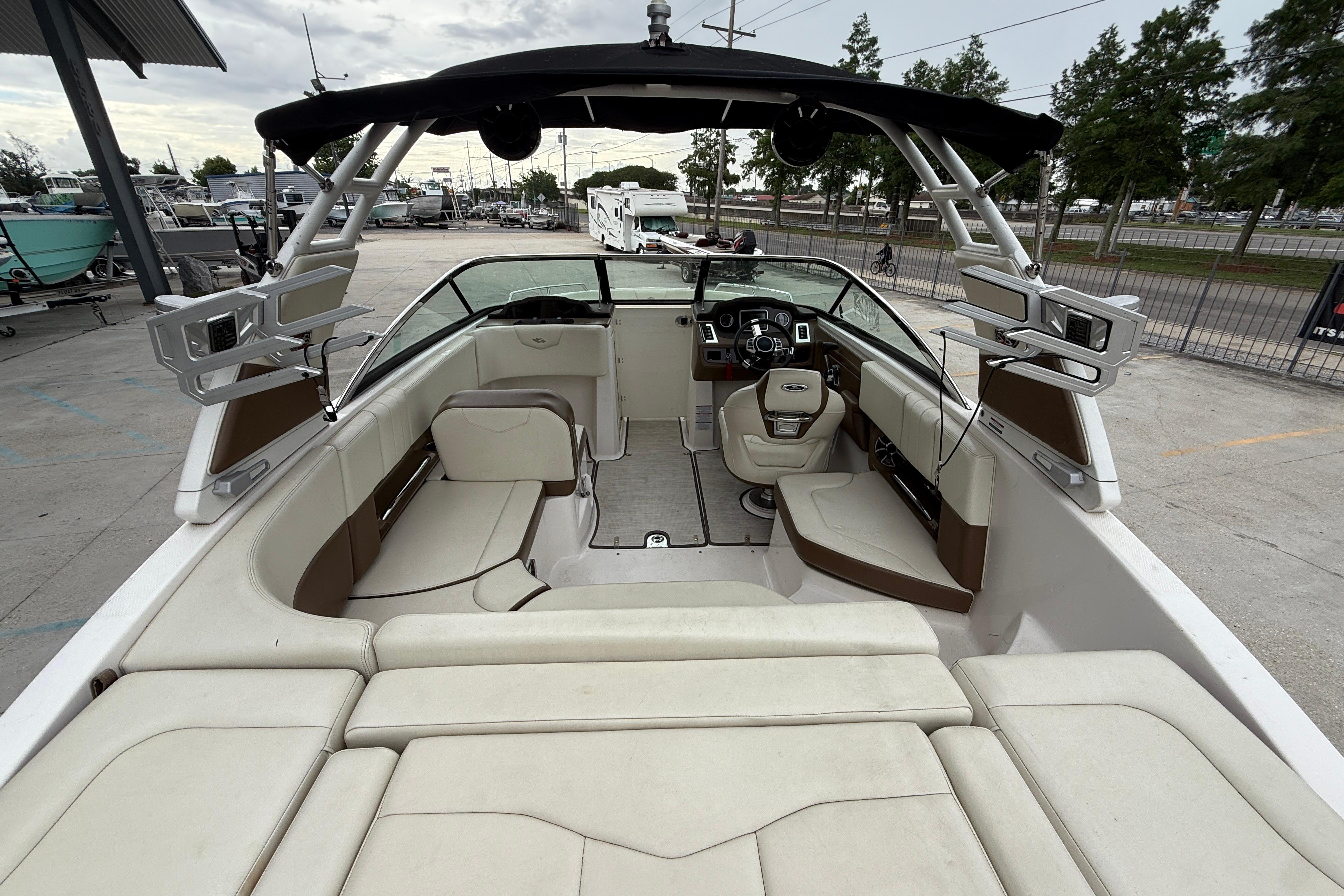 2018 Chaparral 227 SSX Surf boat interior with seating and steering console.