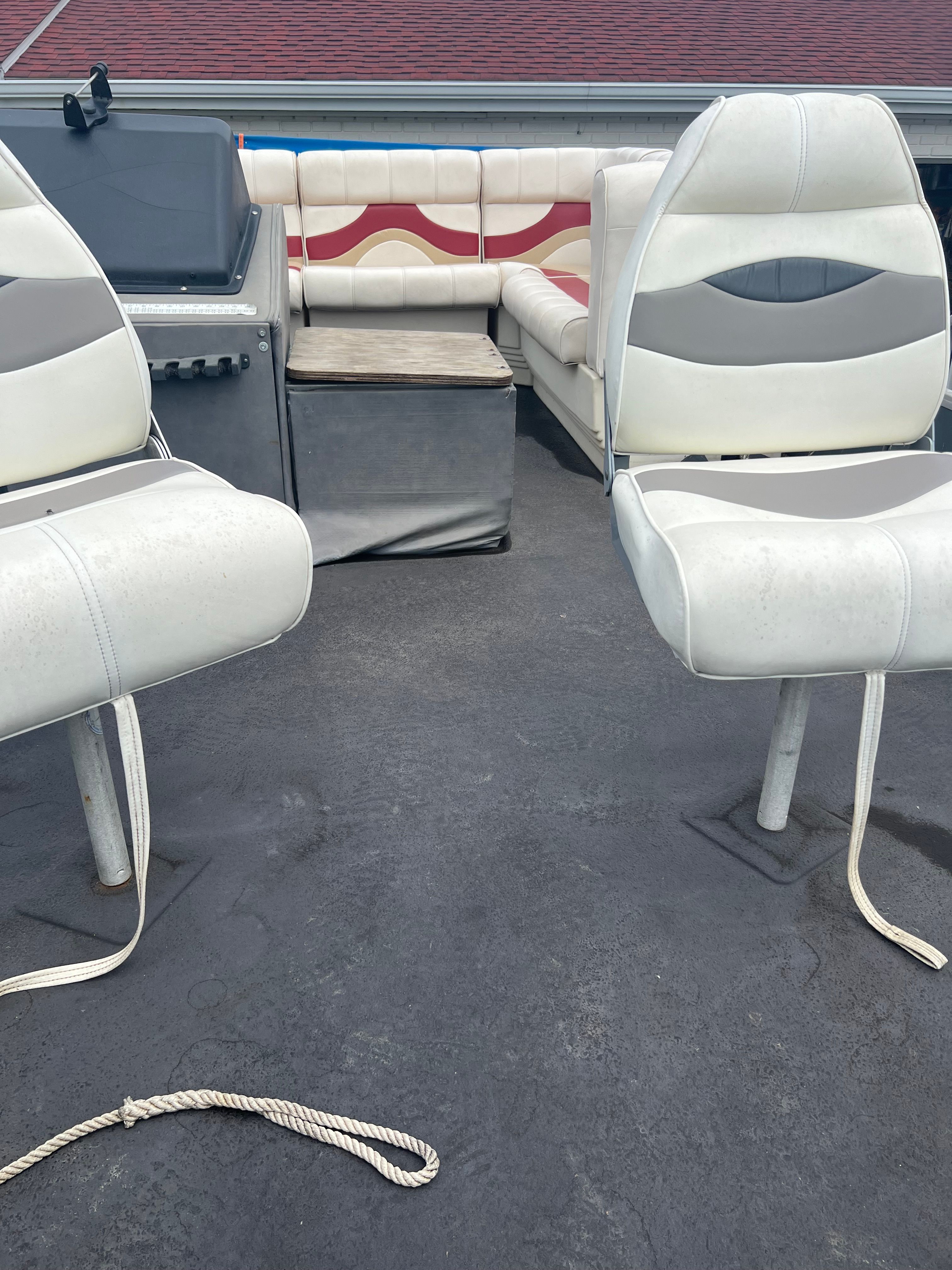 Interior of a 1991 Tracker Bass Buggy with white seats.
