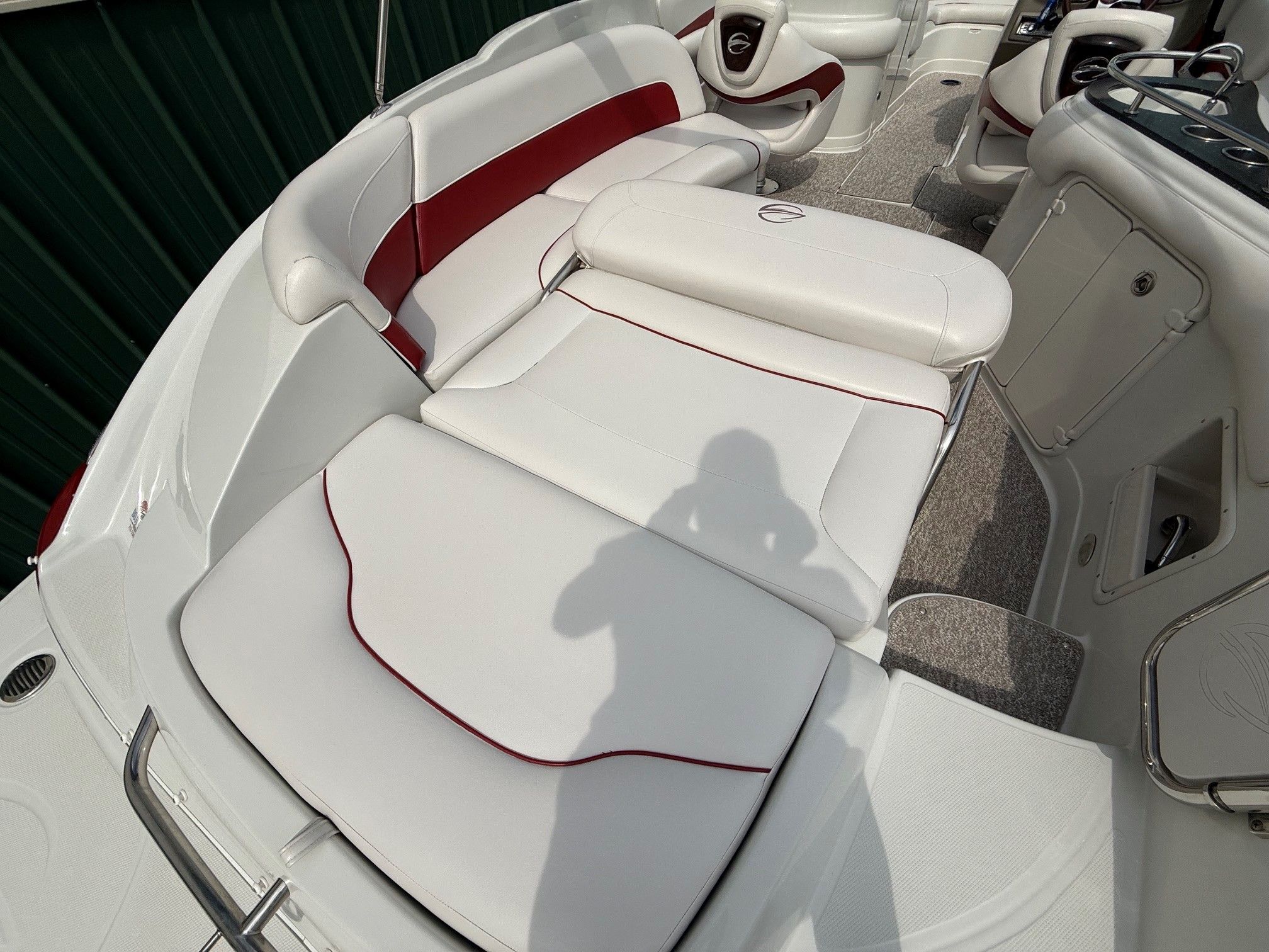 The image shows the interior of a 2012 Crownline 252 EX boat with white and red upholstery.