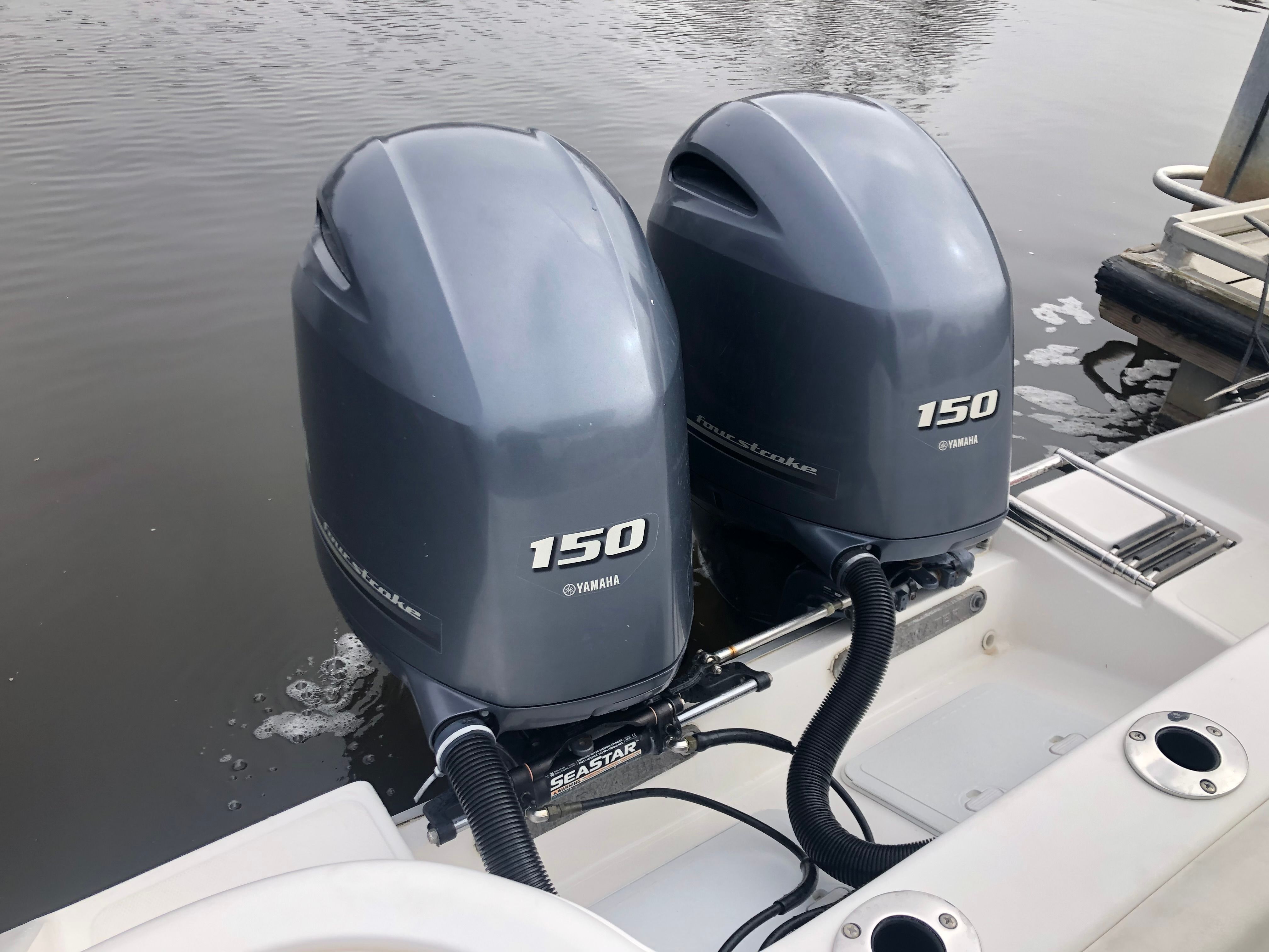 Two Yamaha 150 outboard engines on a boat in the water.