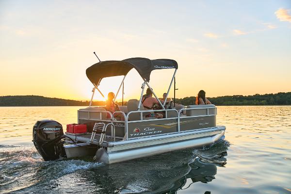 Manufacturer Provided Image: 2025 Sun Tracker Party Barge 16 DLX pontoon boat cruising at sunset on a serene lake.