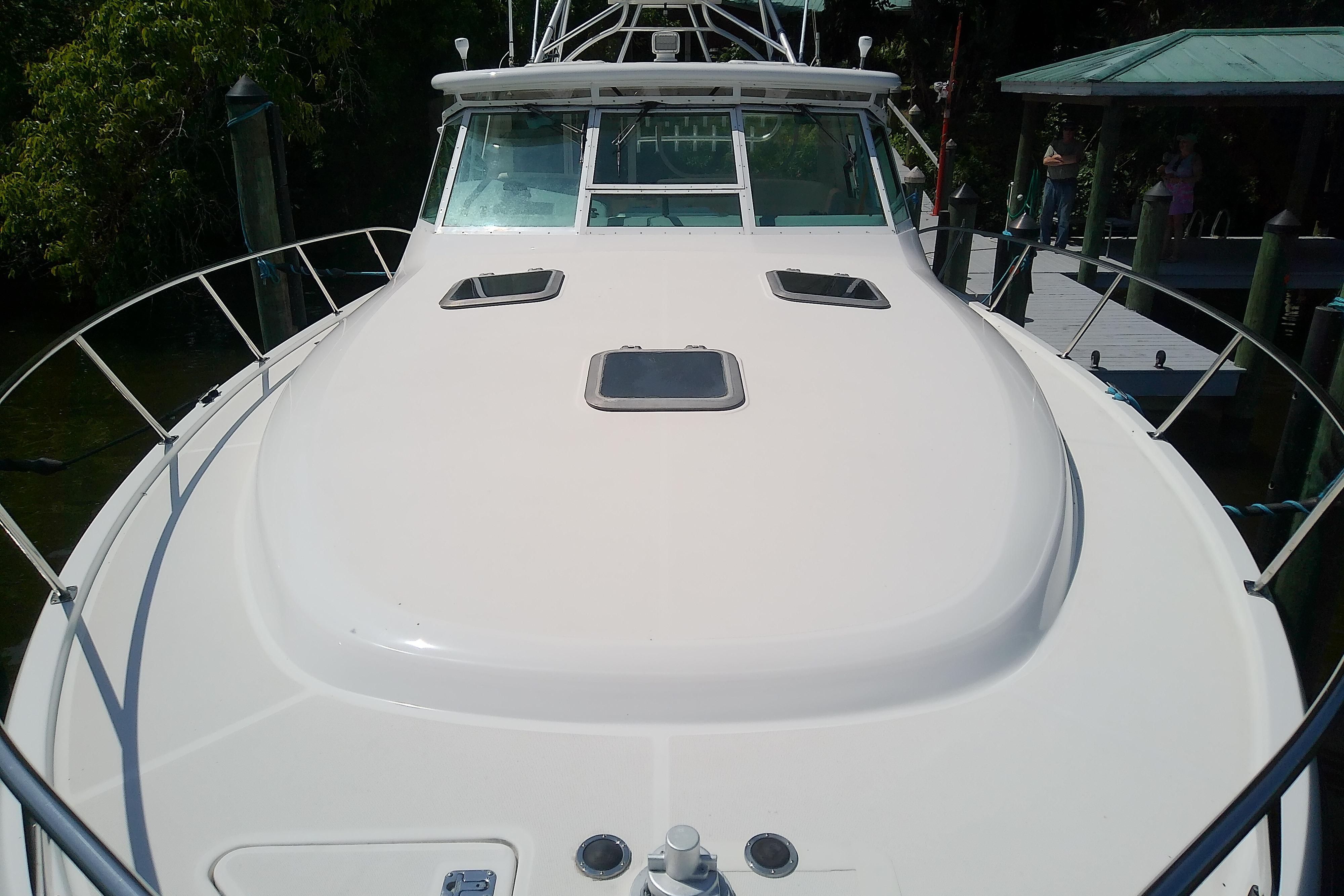 2000 Tiara Yachts 4100 Open boat docked, showcasing sleek deck design and windows.