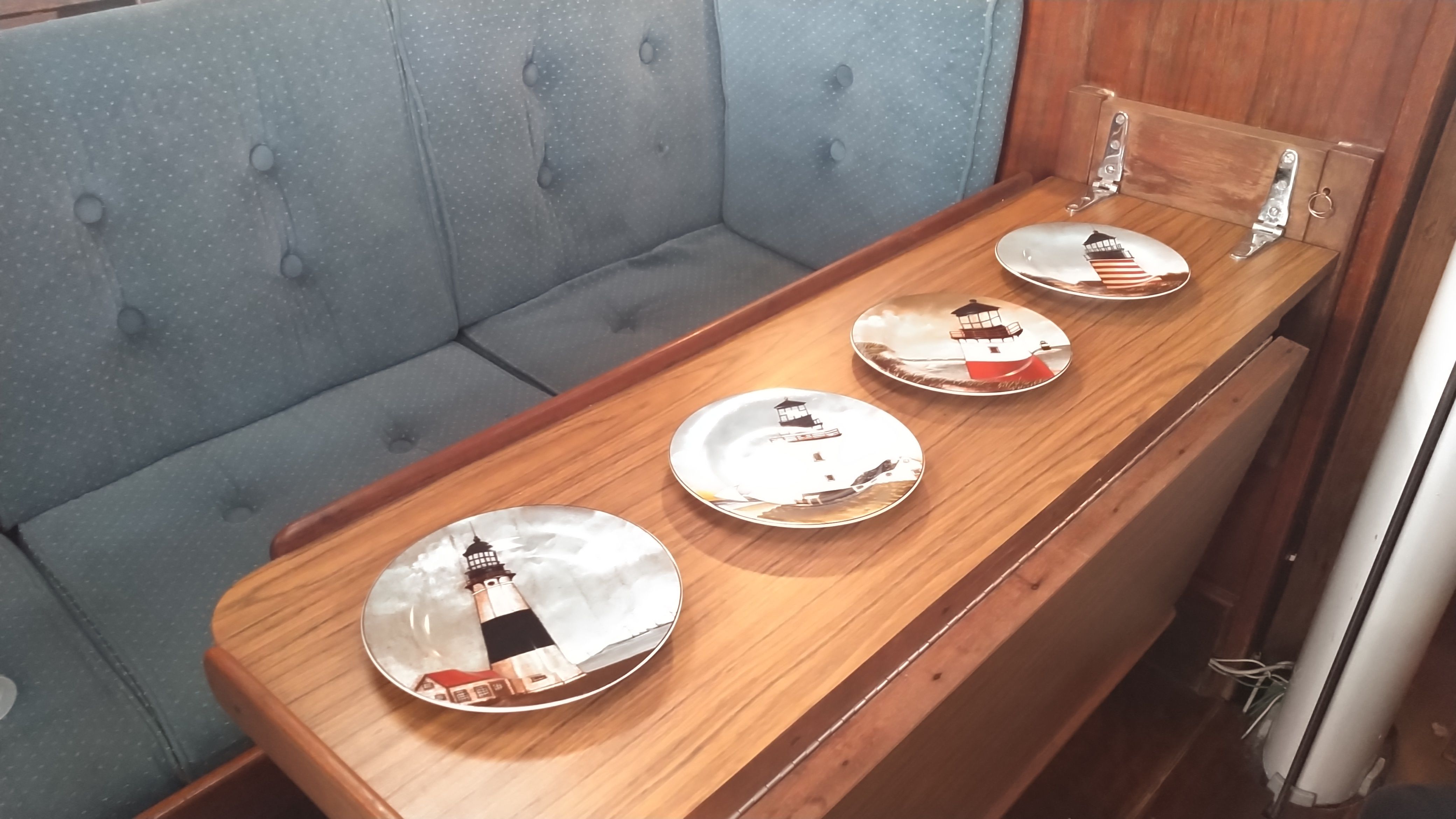 Interior of a 1978 Tartan 37 yacht with decorative lighthouse plates.