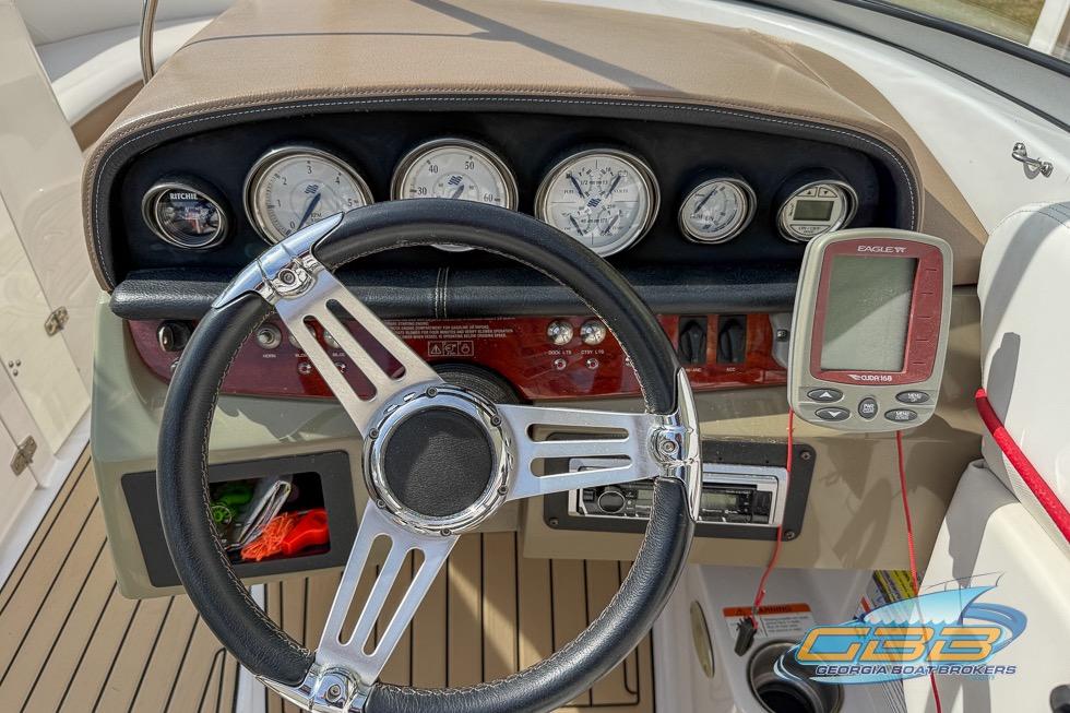 2008 Four Winns F224 boat dashboard with steering wheel and gauges.