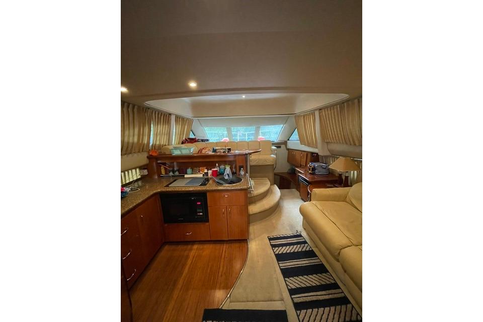 Interior of 2003 Carver 36 Super Sport yacht with kitchen and seating area.