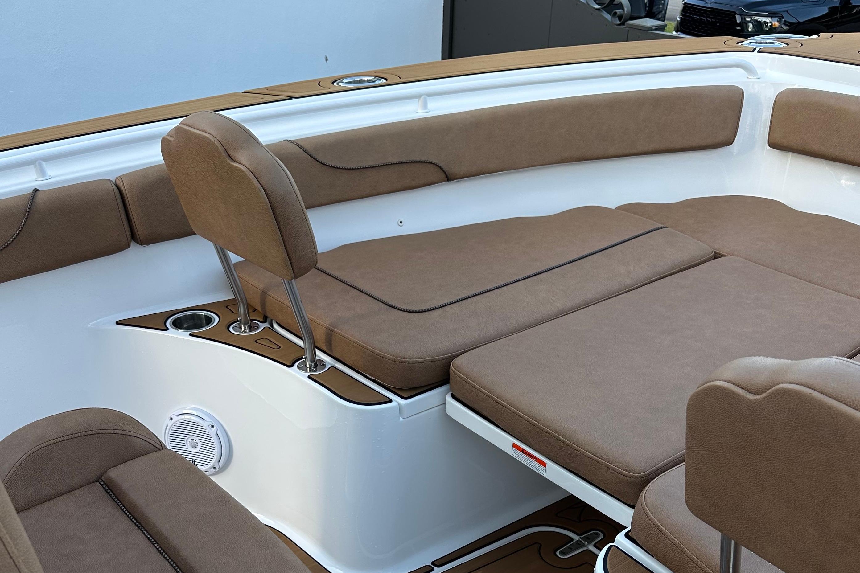 2019 Sea Hunt Gamefish 25 boat interior with brown cushioned seating and cup holders.
