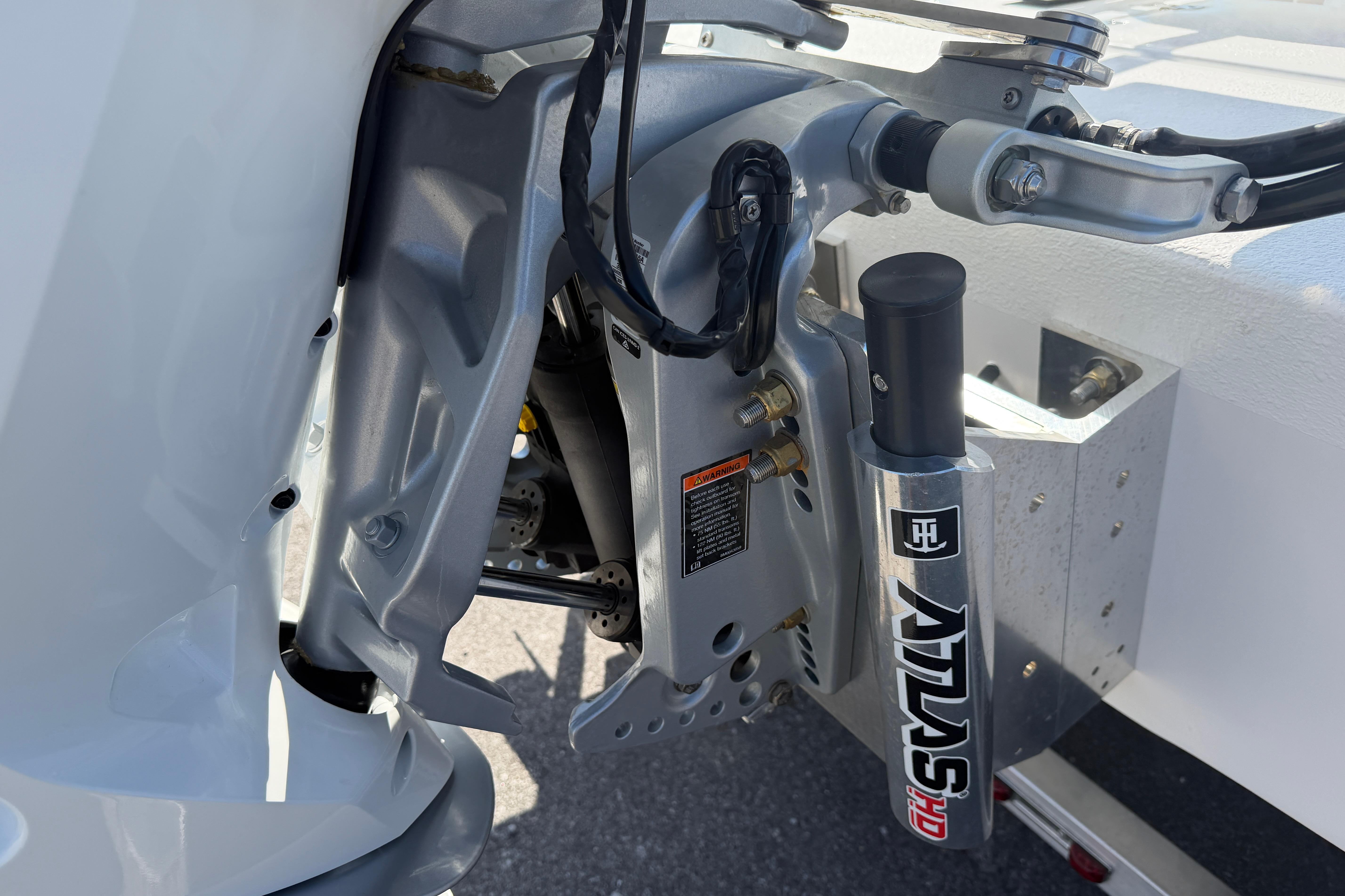 Close-up of 2026 Skuta 24 Cat boat engine mount and hydraulic system.
