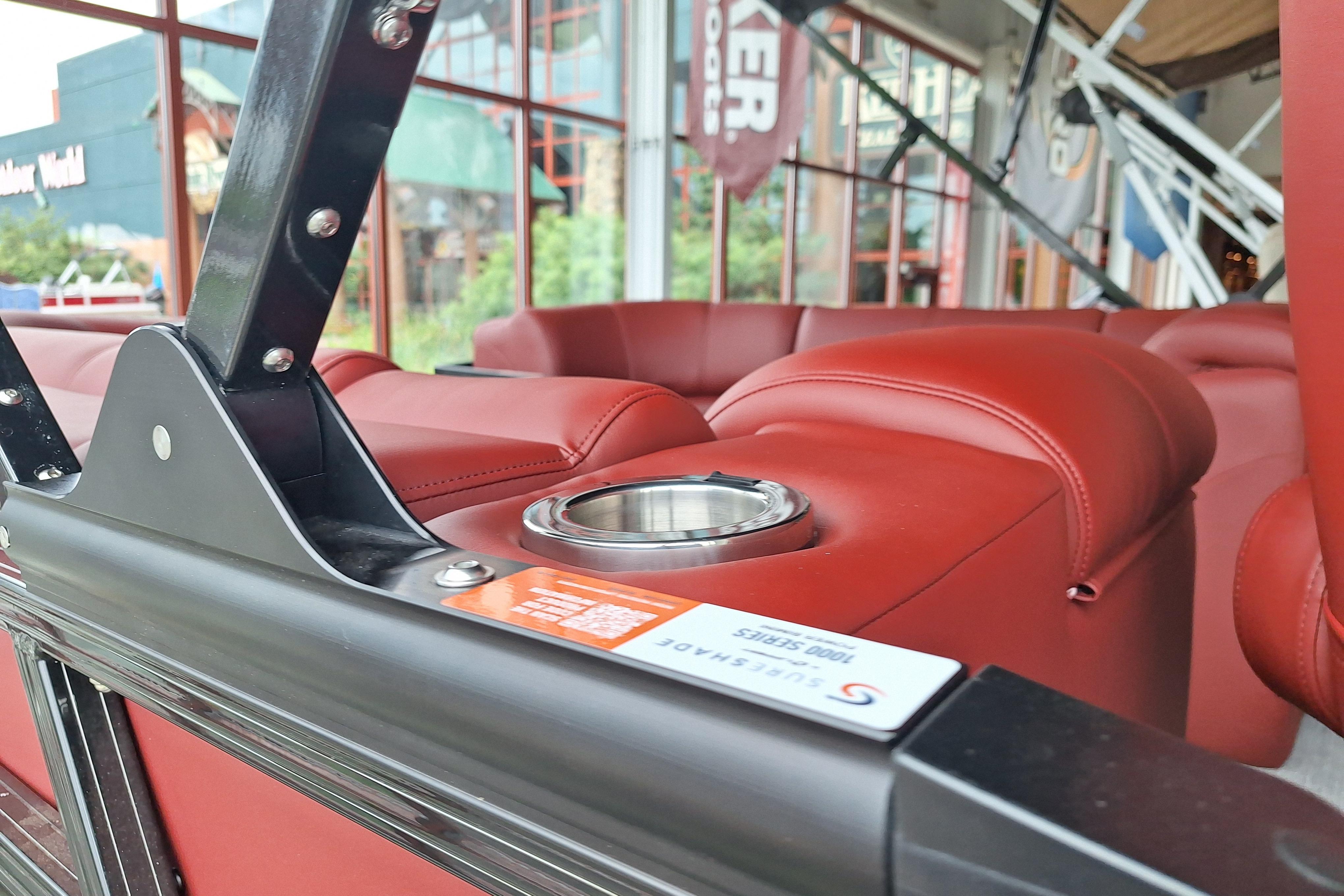 Red leather seating with cup holder in 2026 Regency 230 DL boat interior.