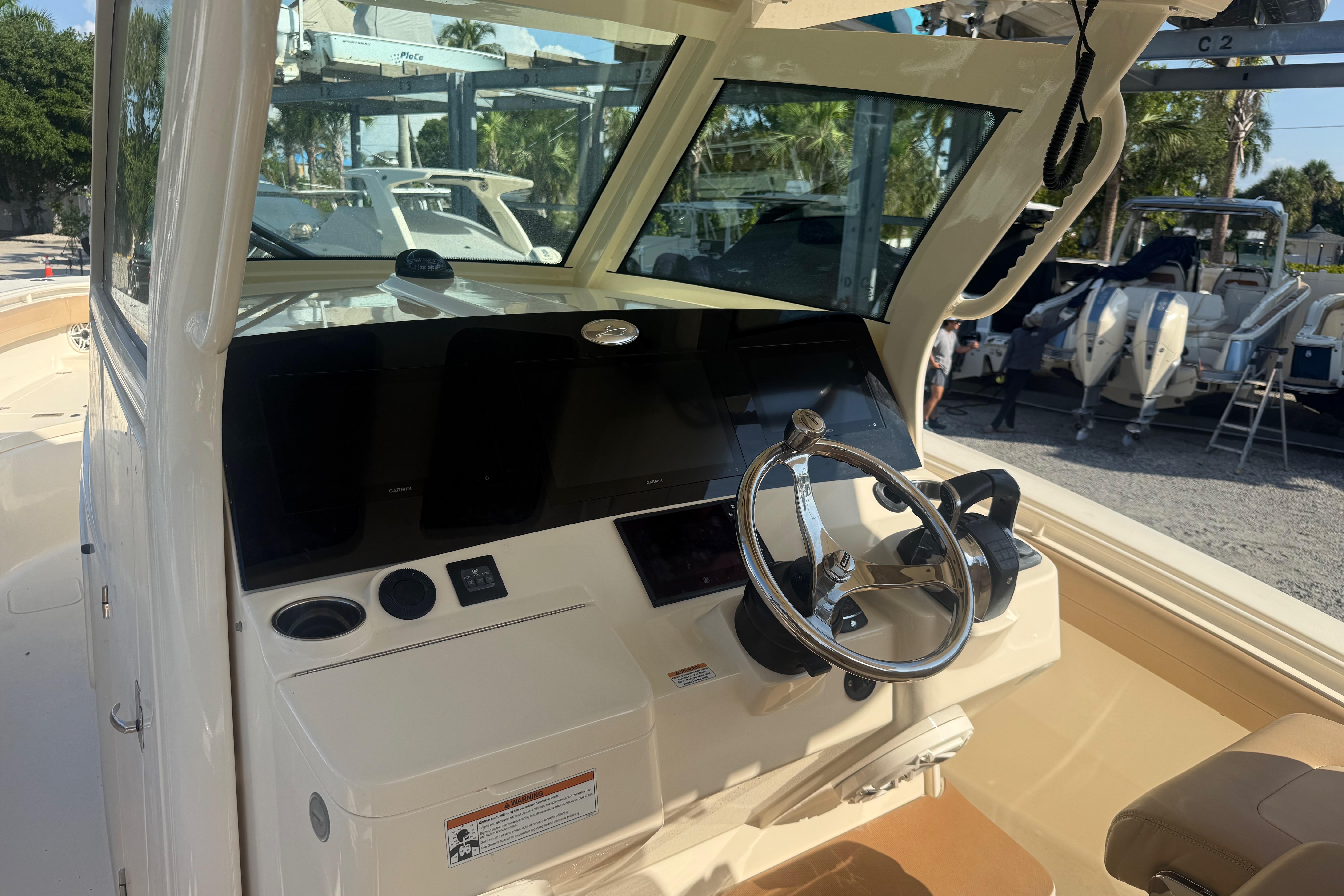 2022 Scout 355 LXF boat helm with steering wheel and control panel.