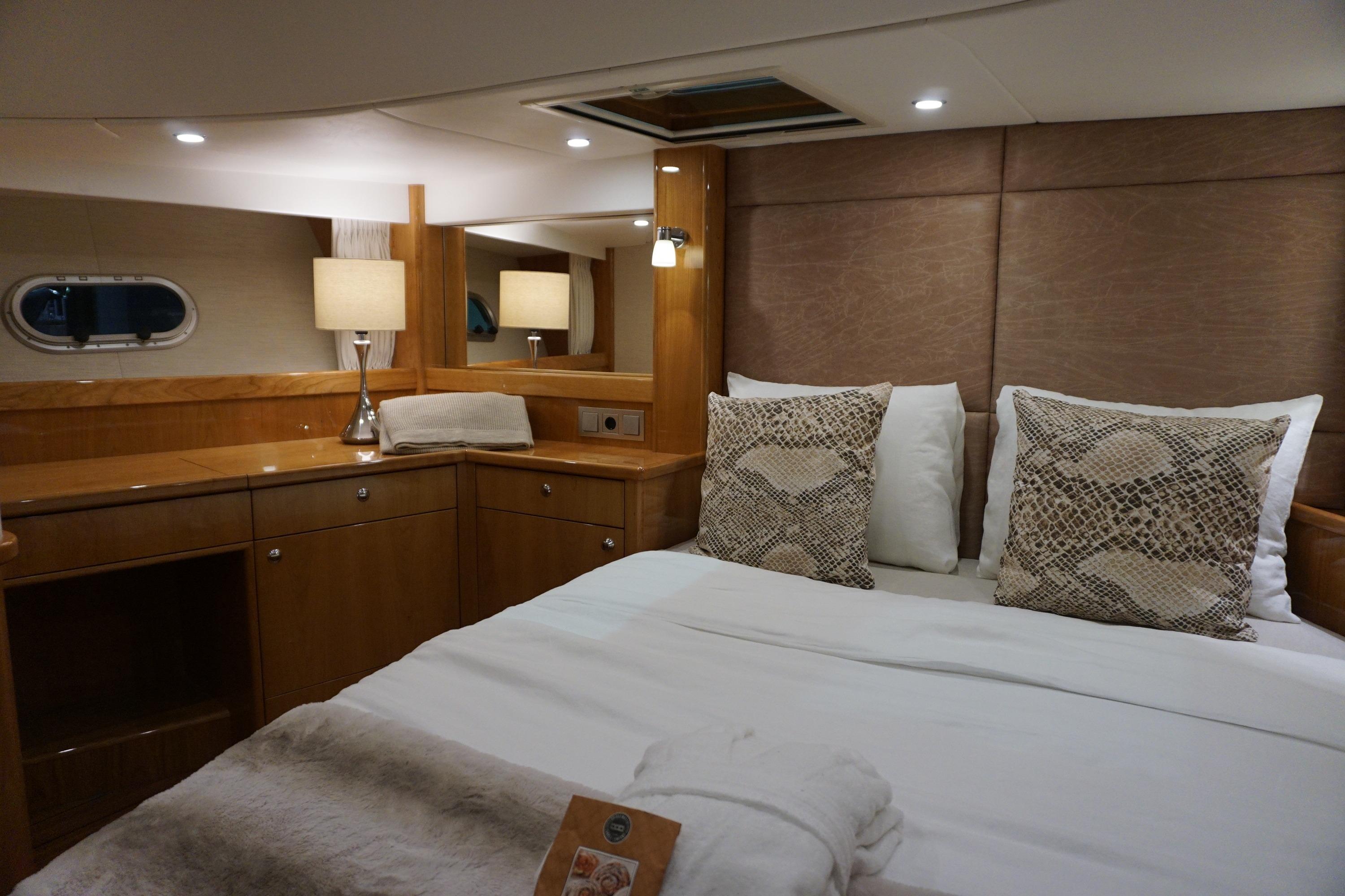 Luxurious cabin interior of 2026 Elling E6 yacht with elegant bedding and wood finish.