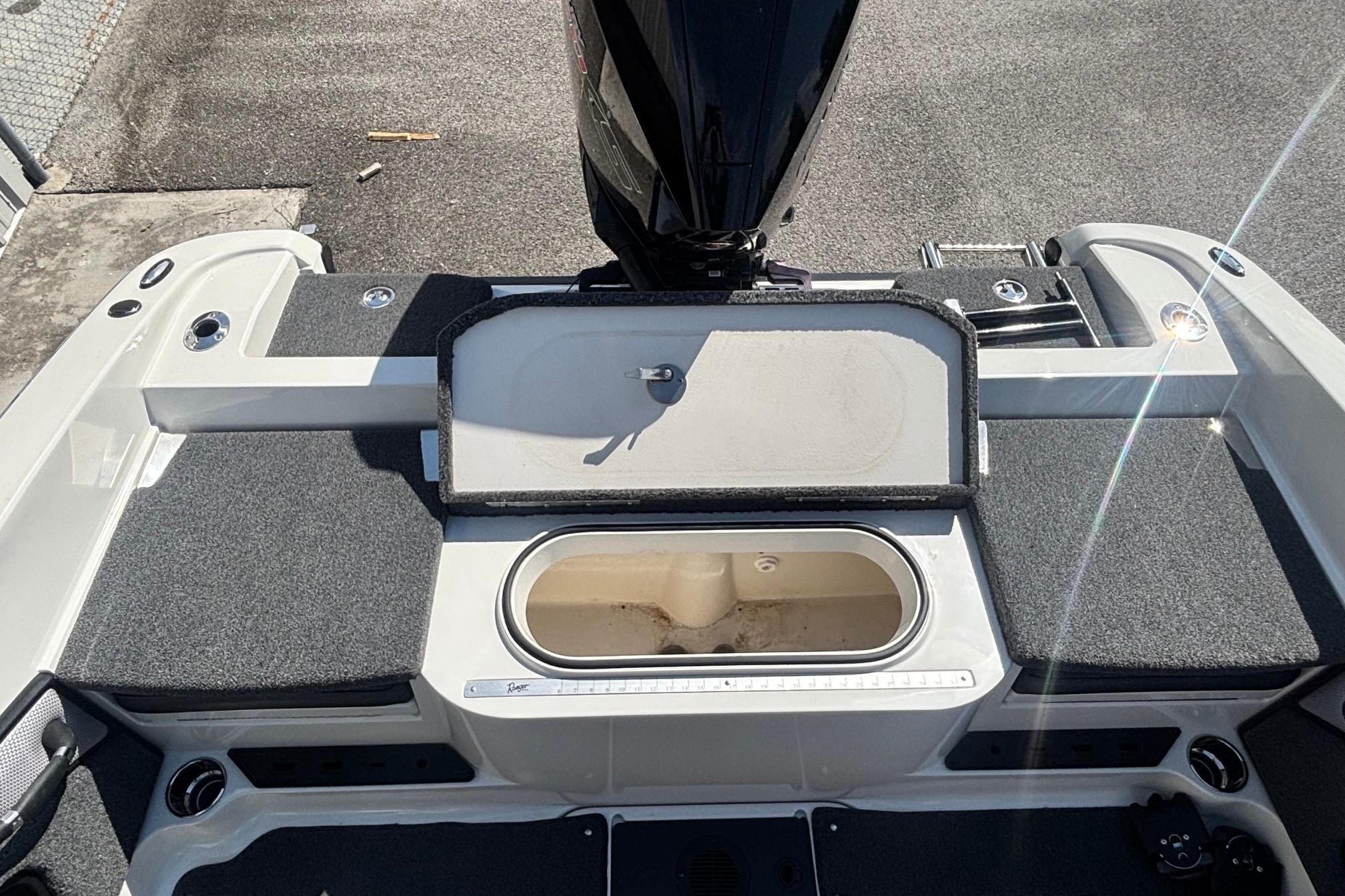2022 Ranger 1880MS boat deck with storage compartment and motor, featuring sleek design.