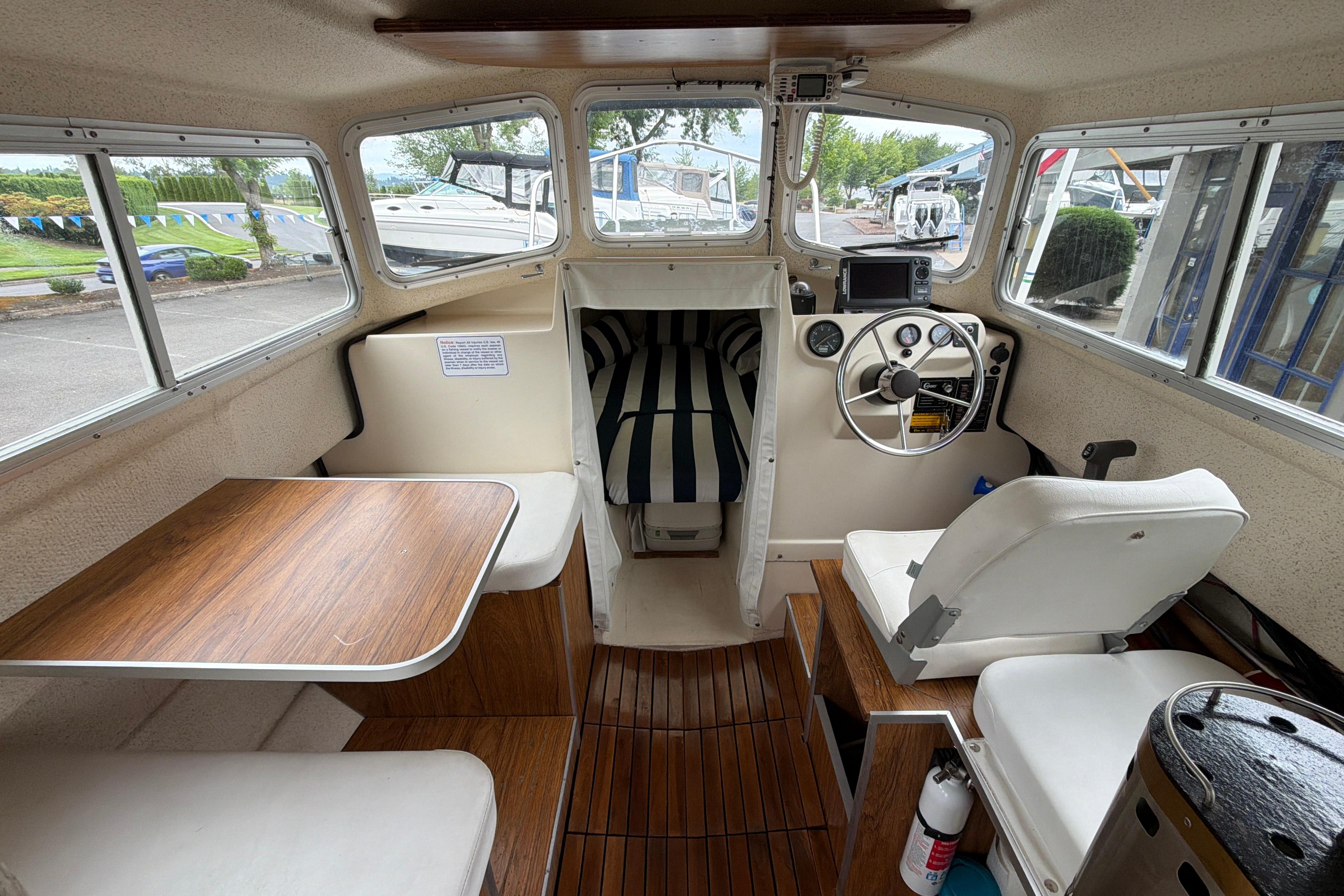 Interior of a 1989 C-Dory 22' Angler boat with seating and steering wheel.