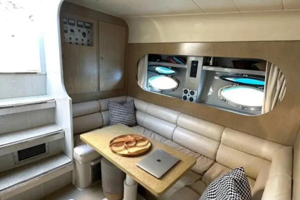 Interior of 1989 Riva TROPICANA 43 yacht with cozy seating and table.