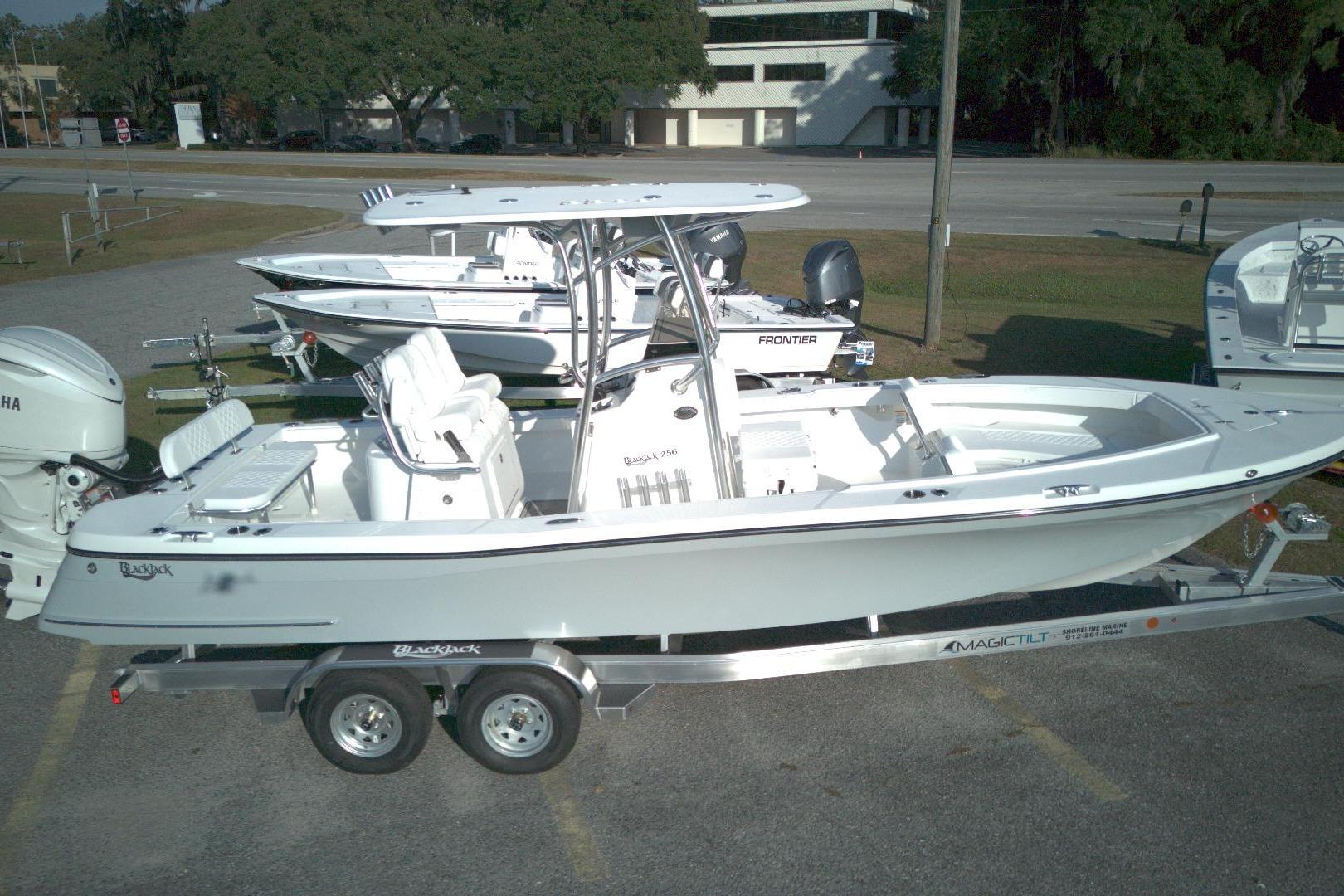 2026 BlackJack 256 Coastal boat on trailer, parked outdoors, side view.