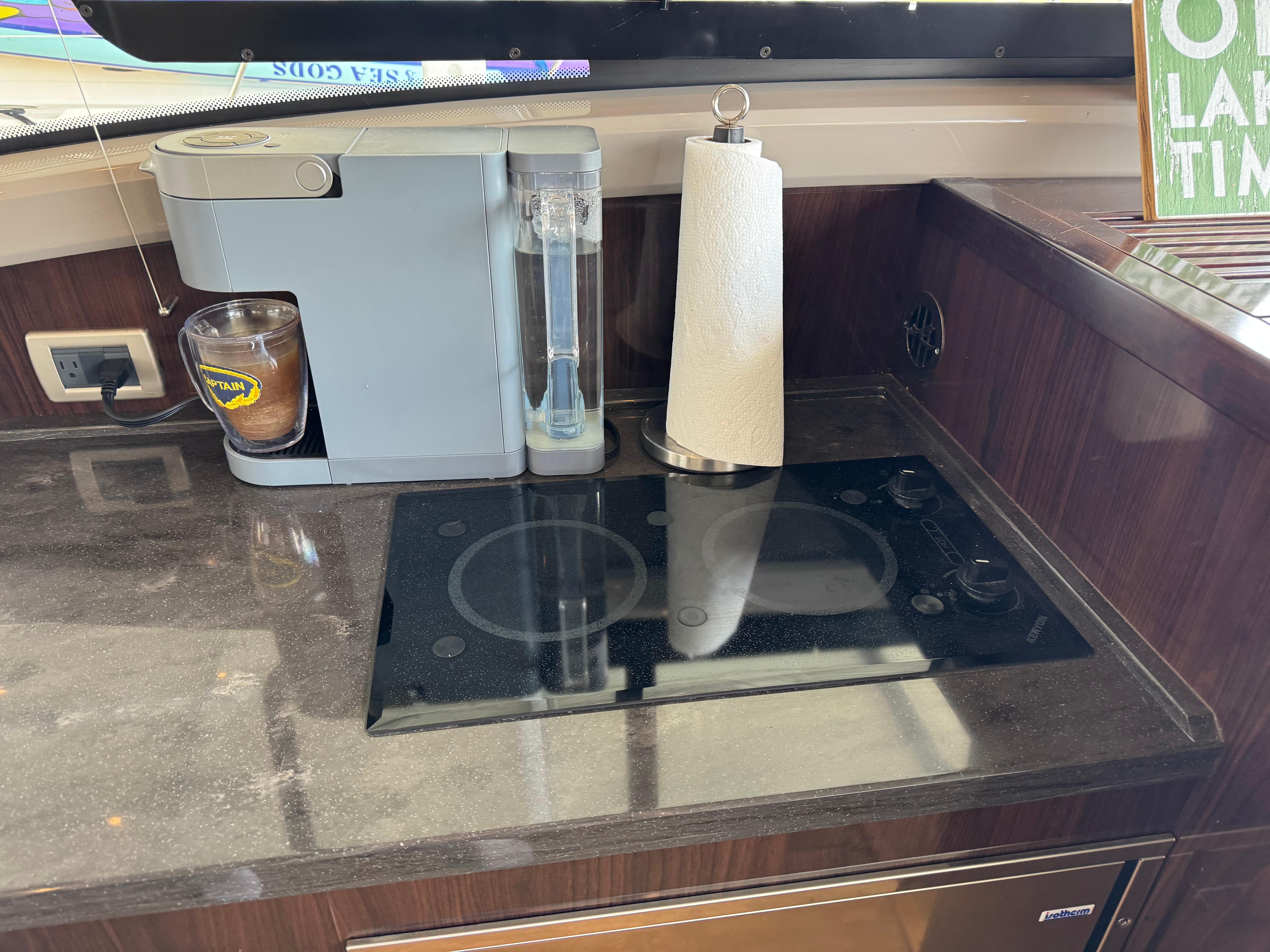 Galley of 2017 Sea Ray Sundancer 400 with coffee maker and stovetop.