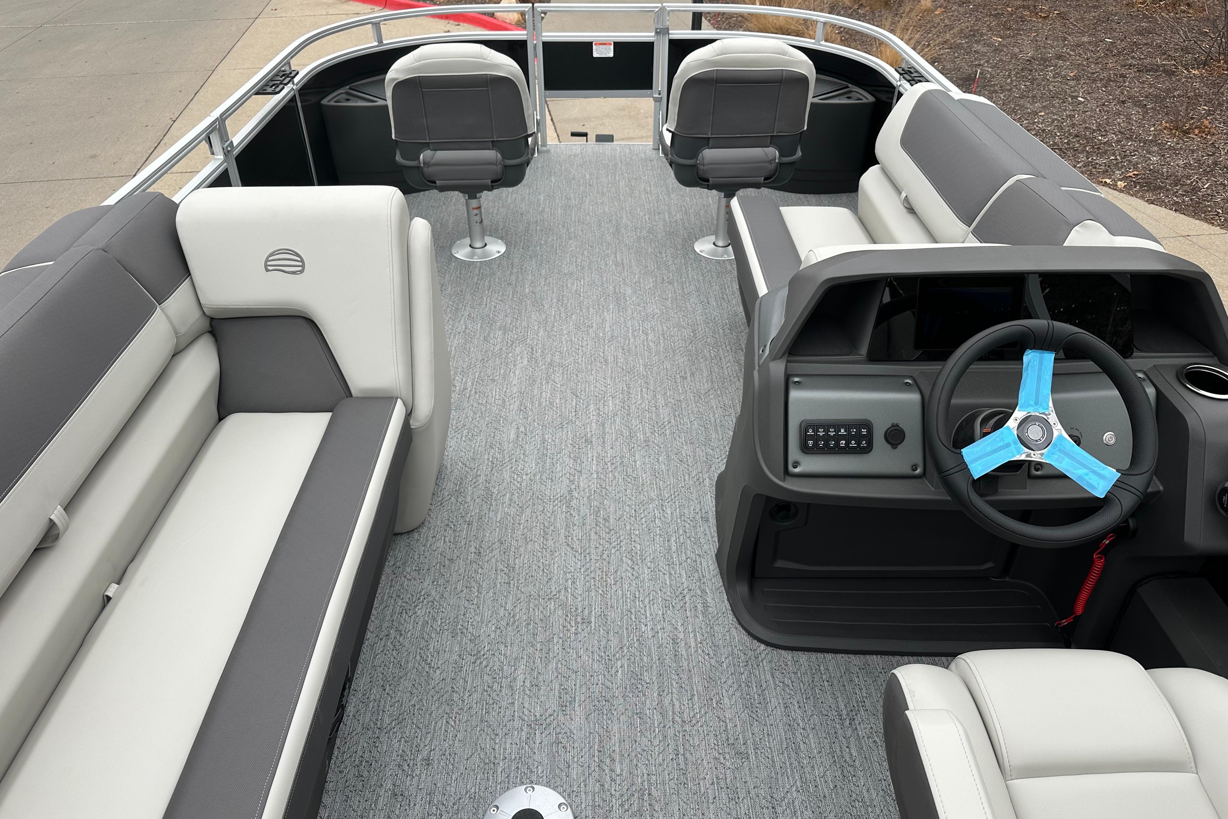 2026 Sun Tracker Fishin' Barge 22 DLX interior with seating and steering console.