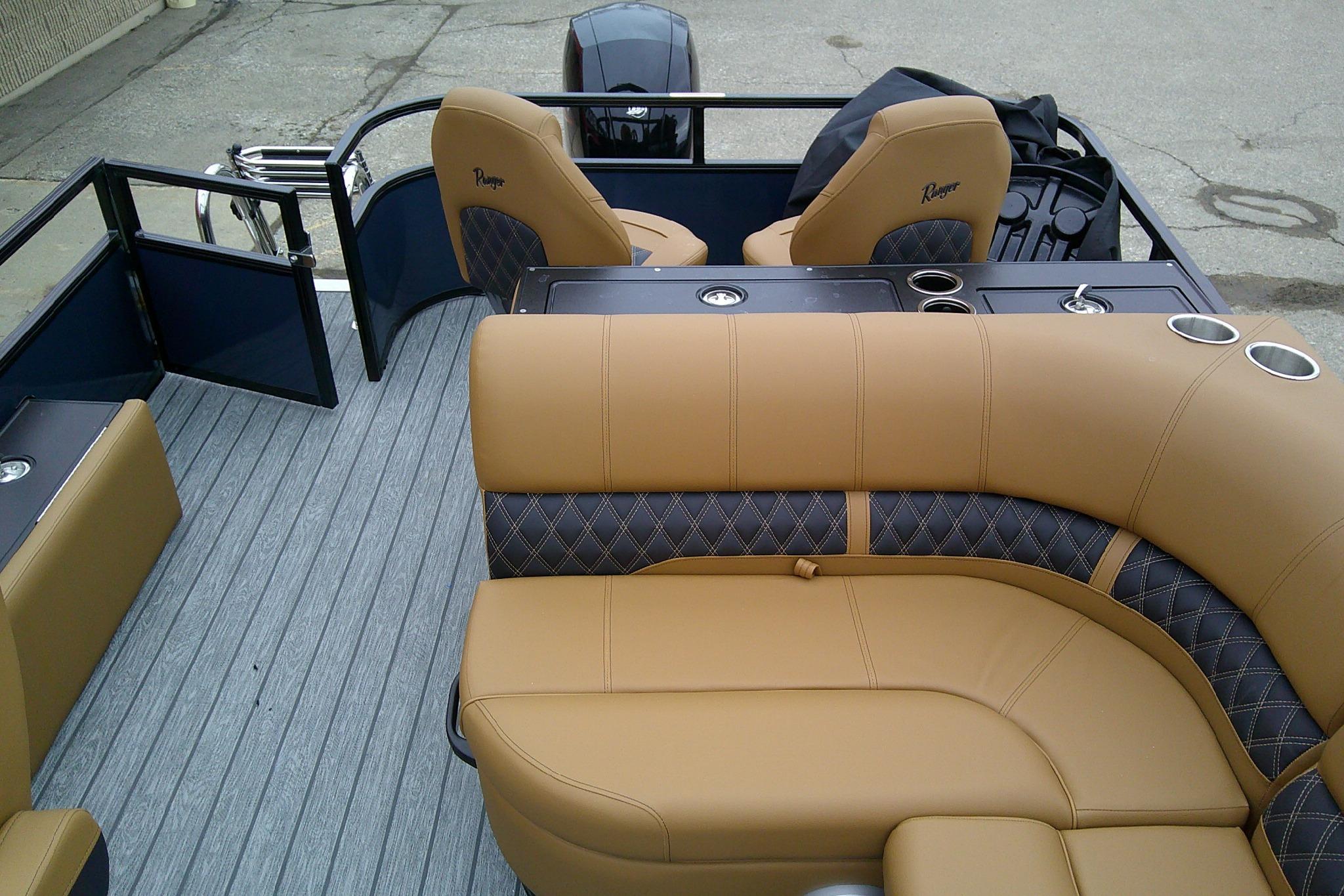2026 Ranger 220FC boat interior with tan and black seating, cup holders, and gray flooring.