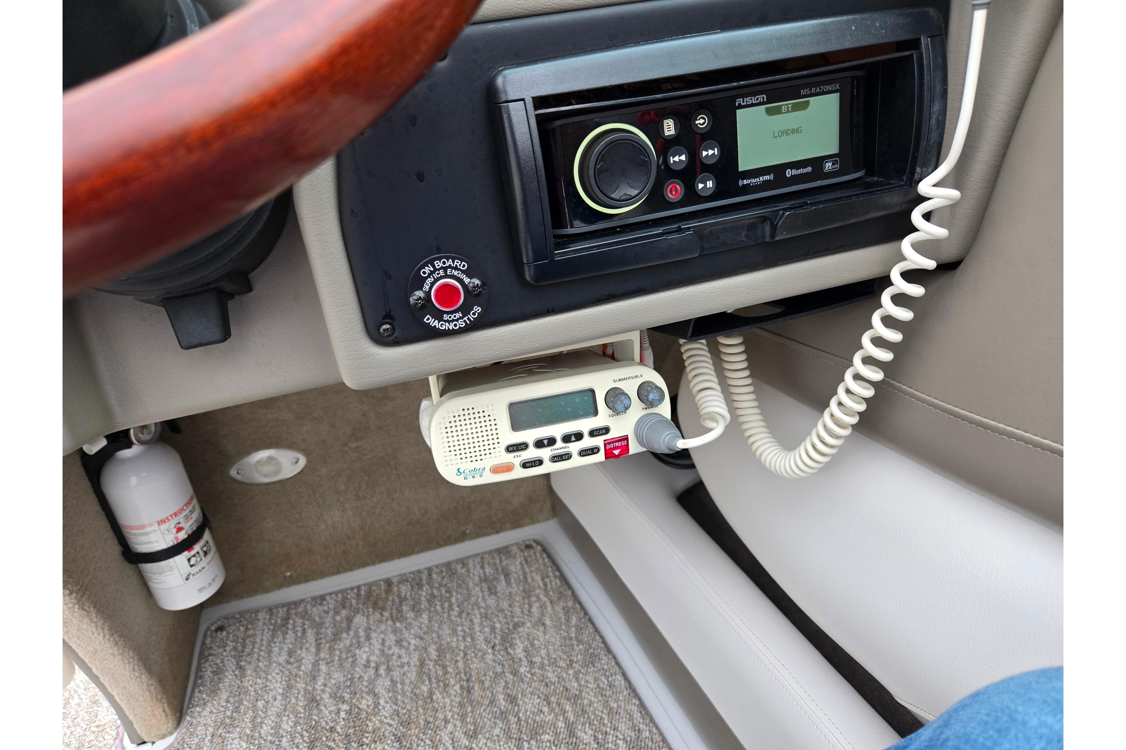 2012 Crownline 235 SS dashboard with stereo system and communication radio.