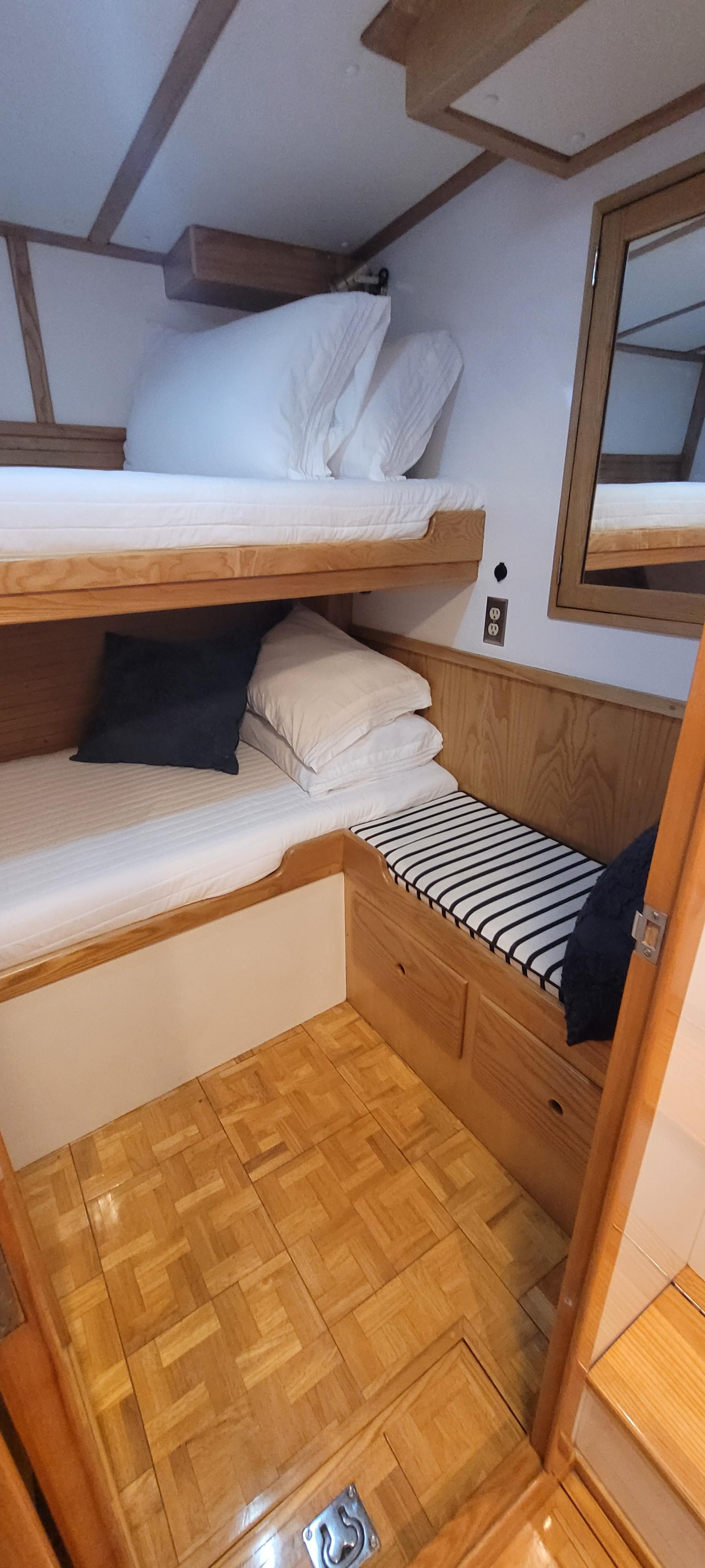 Cozy cabin interior of 1989 Duffy Wilbur 42 Flybridge Cruiser with wooden bunk beds.