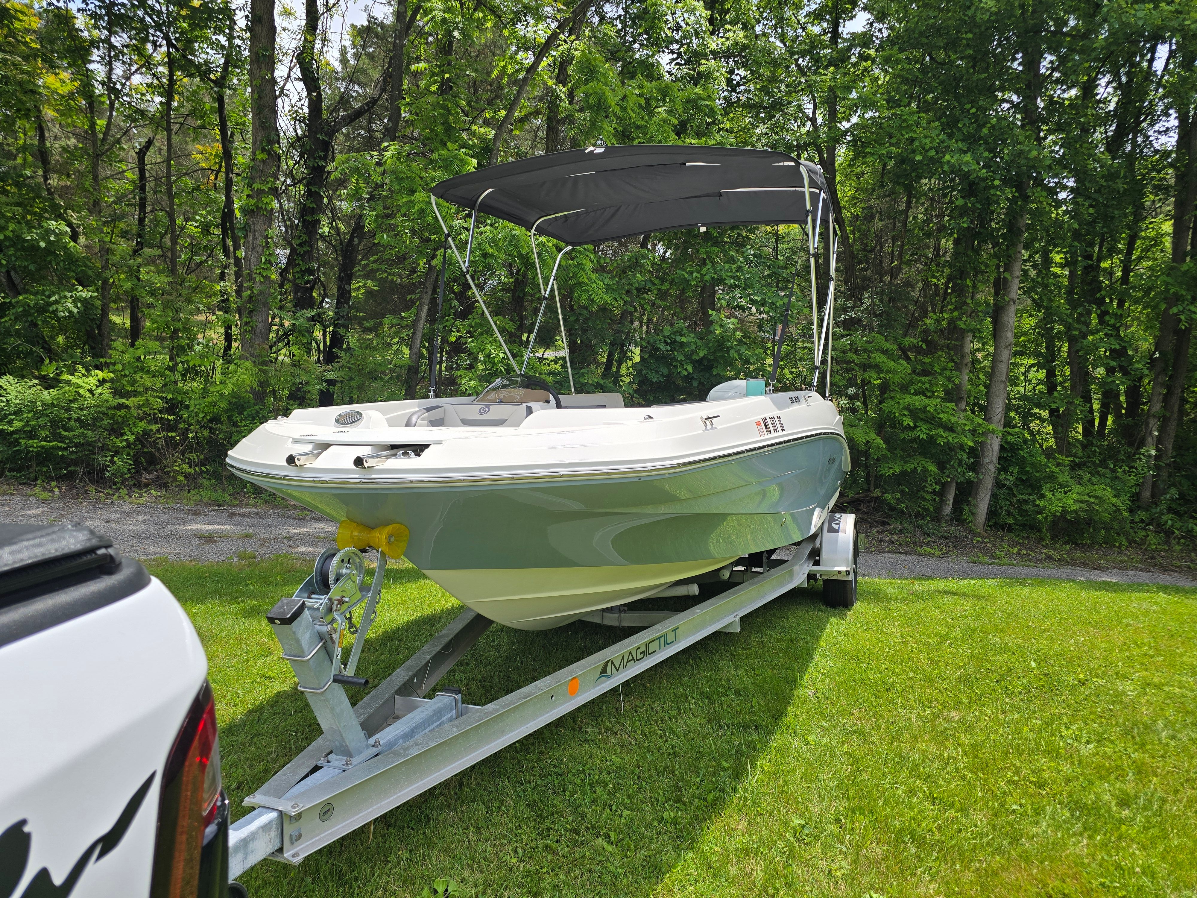2021 Hurricane 205SS boat on trailer in a grassy area.