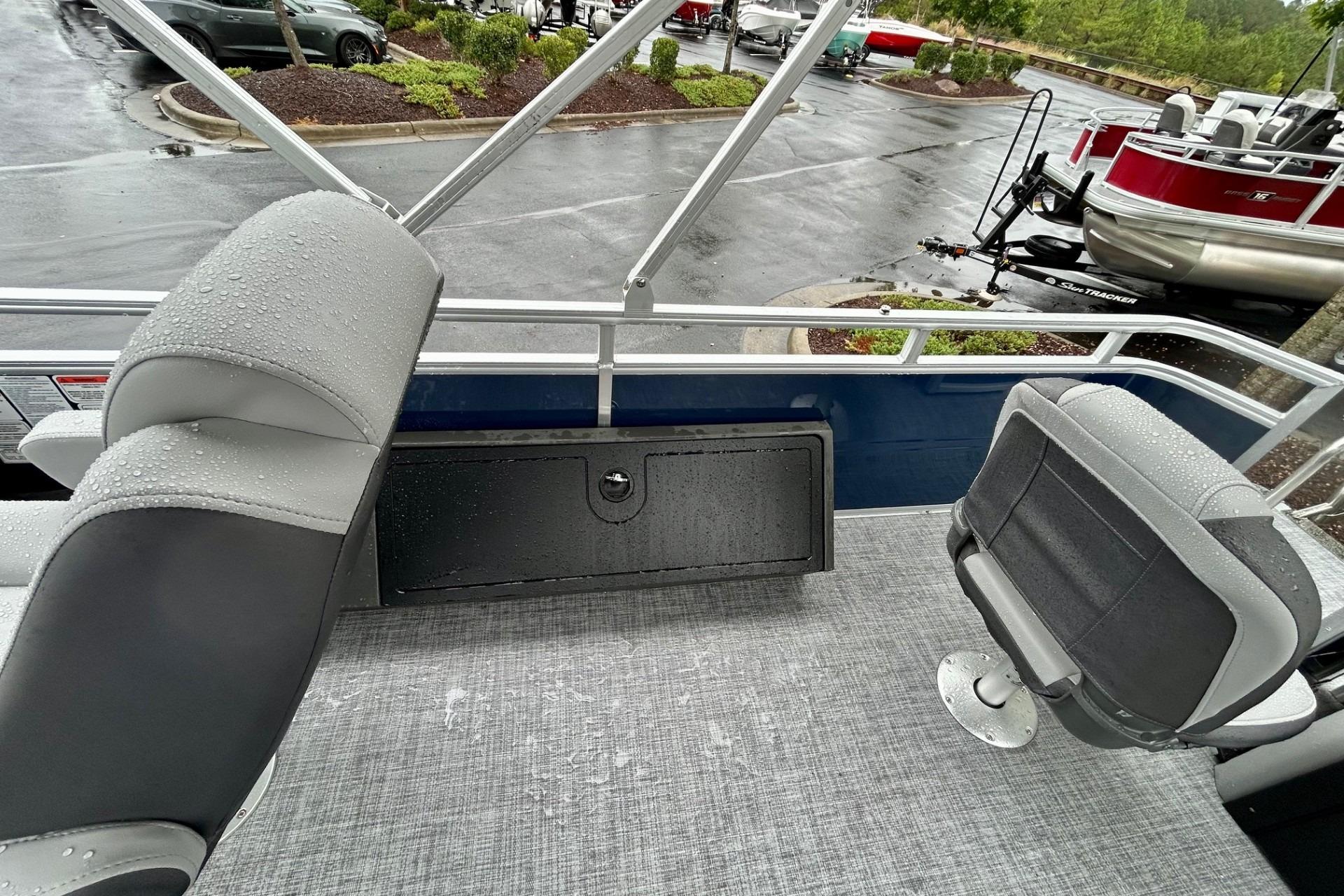 2026 Sun Tracker SportFish 22 DLX boat interior with wet seats and flooring.