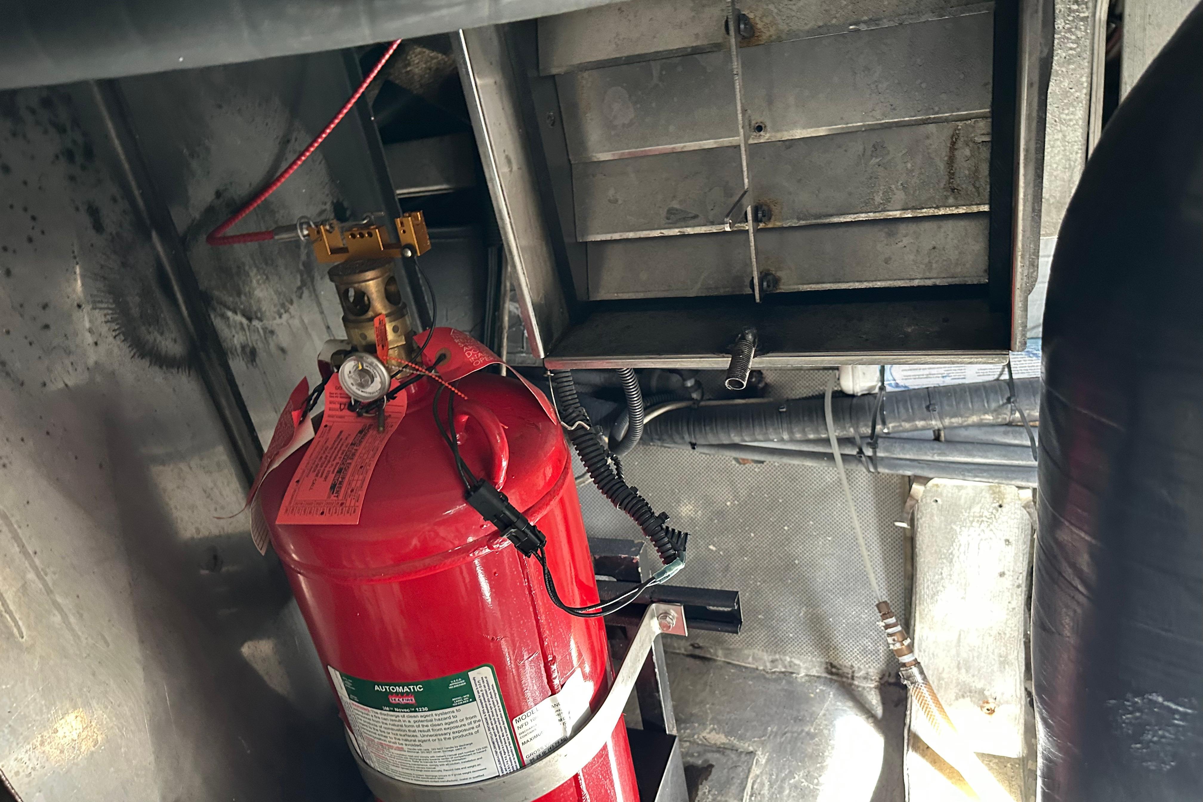 Engine room of 2004 Azimut 55E yacht with fire extinguisher system.