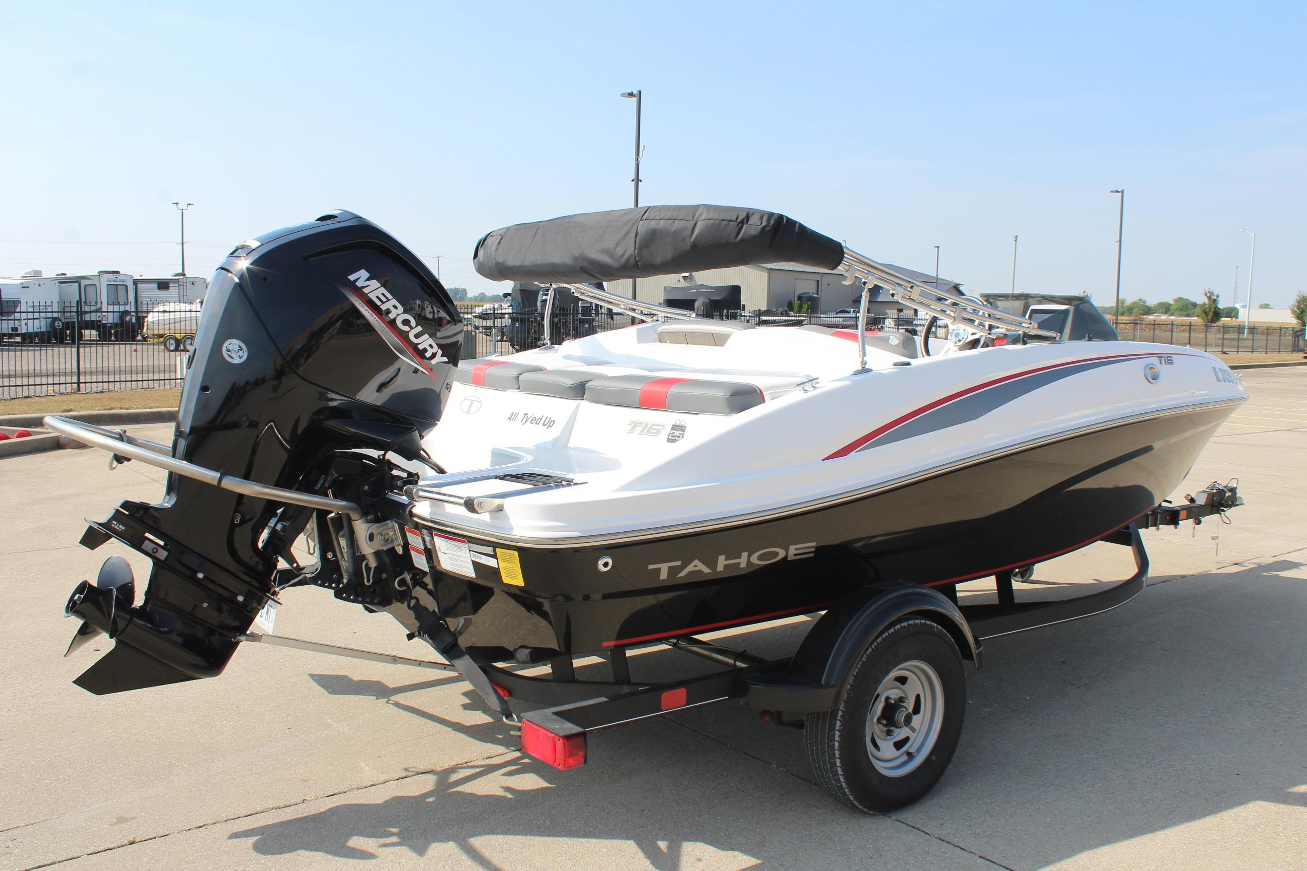 2023 Tahoe T16 boat with Mercury engine on trailer, parked outdoors.
