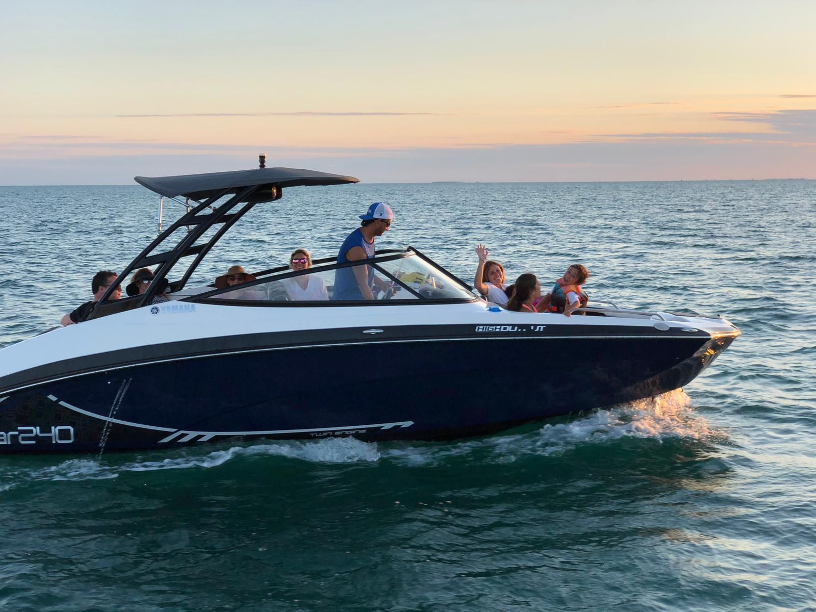 2016 Yamaha AR240 boat cruising on the sea at sunset.
