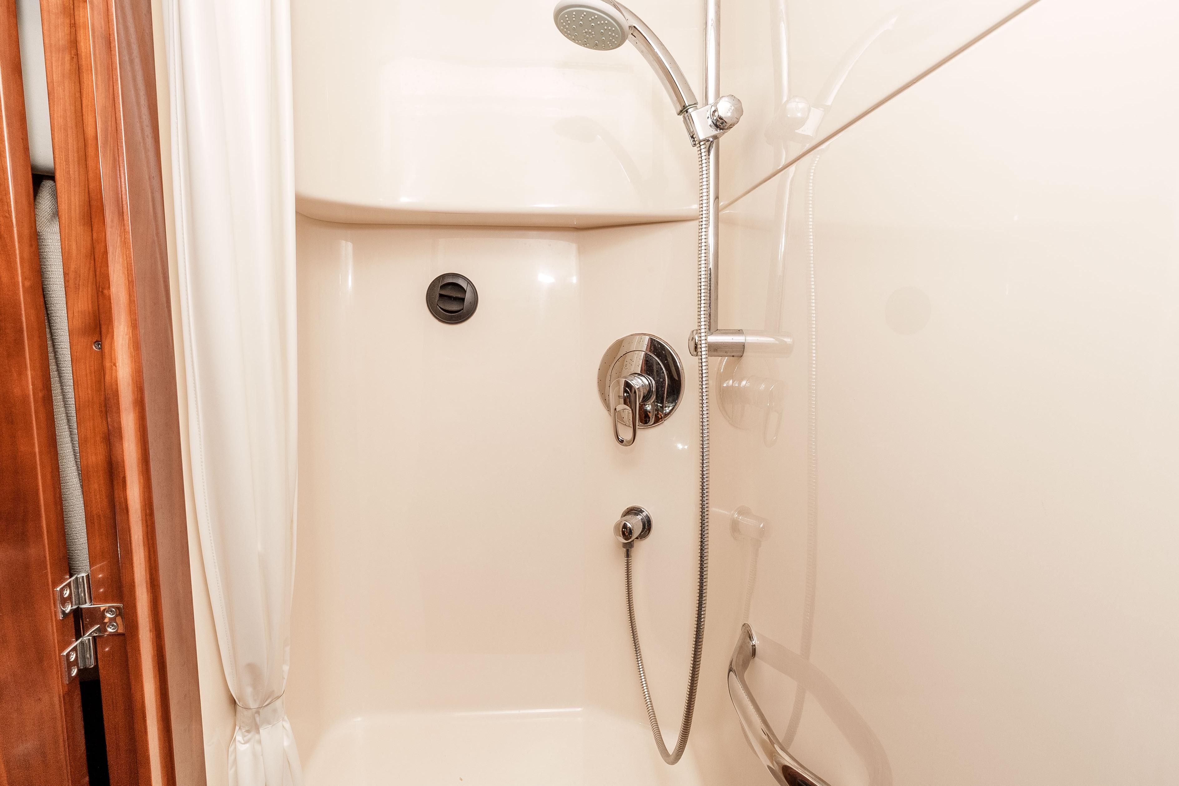 Shower area in 2007 Sea Ray 48 Sundancer yacht, featuring sleek fixtures and curtain.
